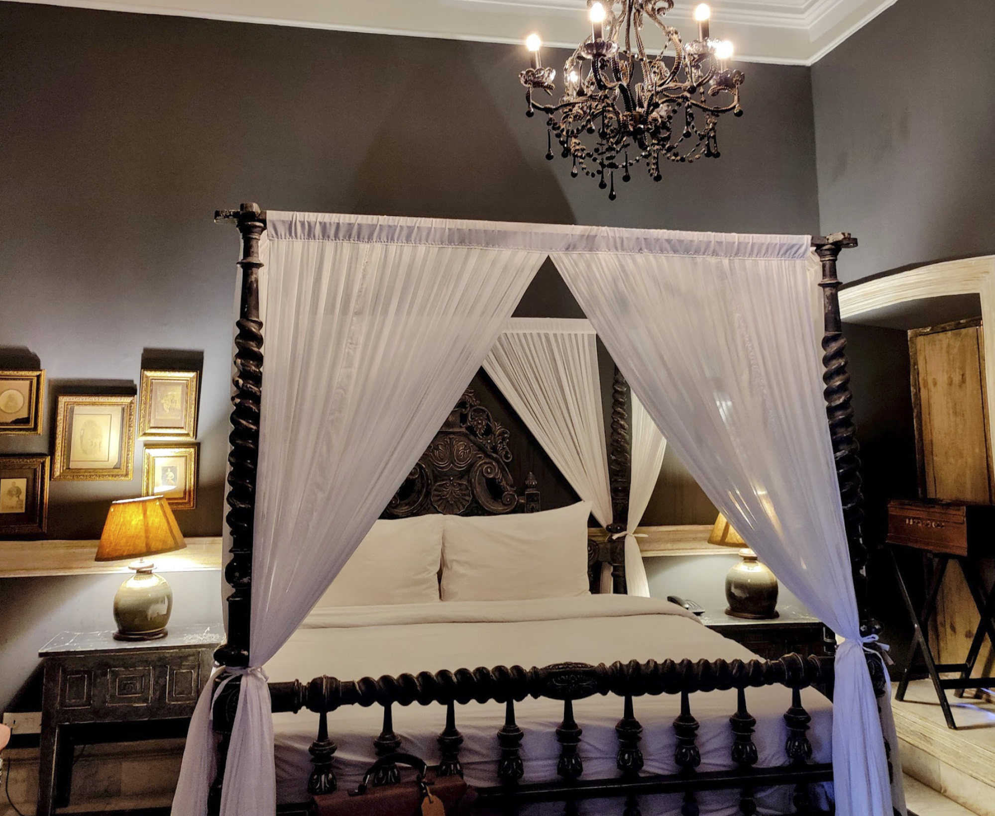 A suite at The Rajbari Bawali, with an antique four-poster bed and high ceiling. Photo: Kalpana Sunder