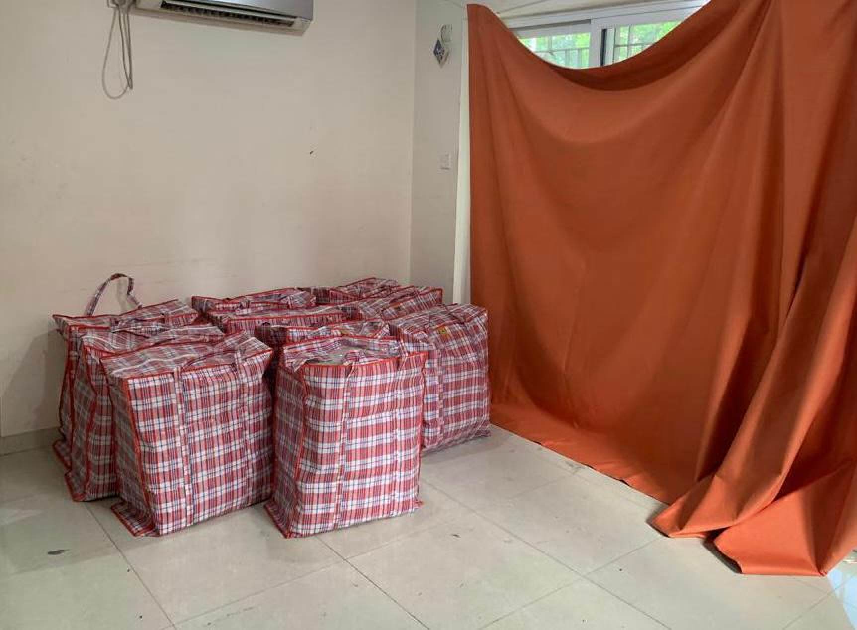 The nylon bags containing 159kg of cannabis buds that were seized from the ground-floor flat of a two-storey house at Kam Tsin Village in Sheung Shui on Thursday. Photo: Handout