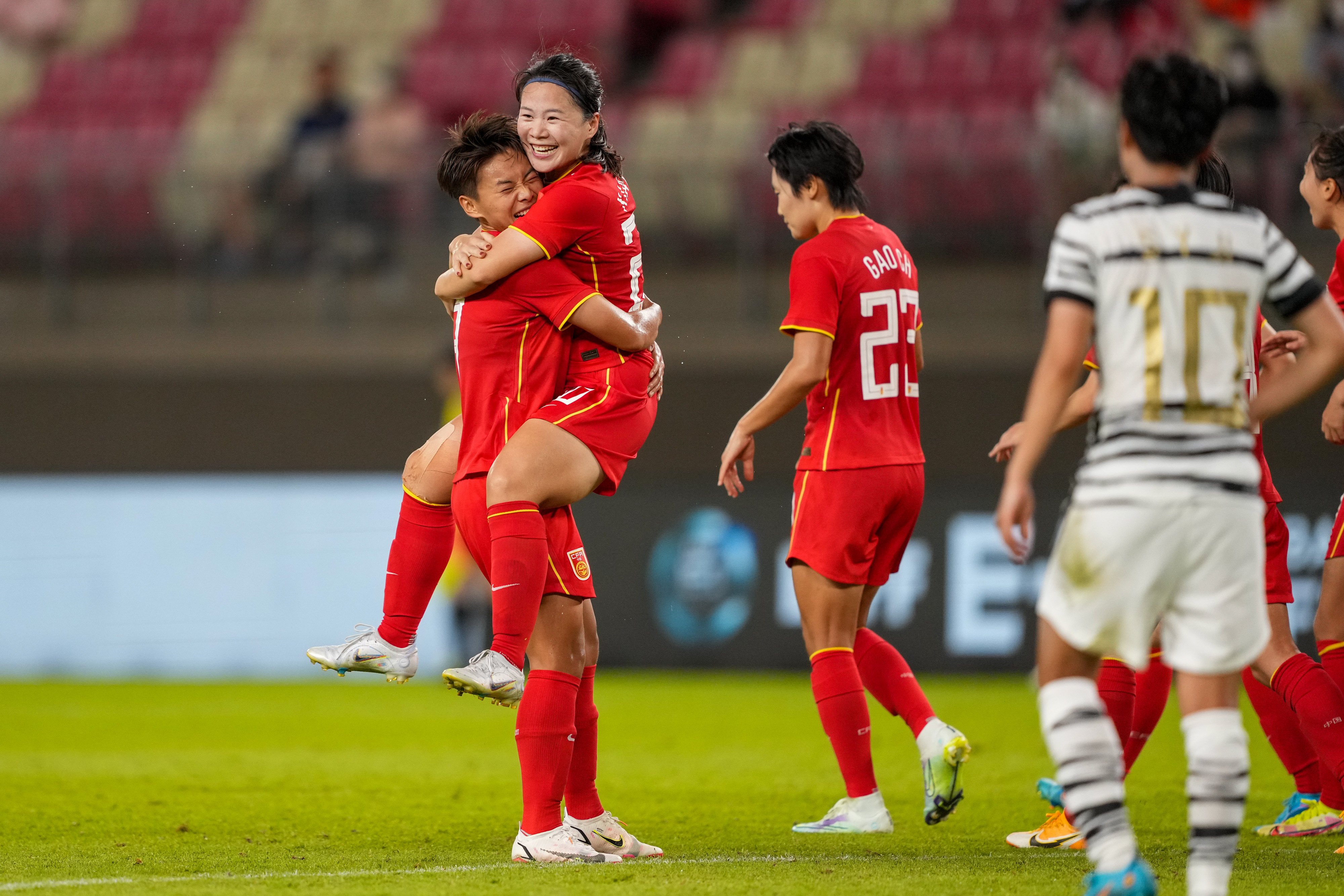 Wang Linlin celebrates with teammate Wang Shuang (left) after scoring the equaliser against South Korea. Photo: Xinhua