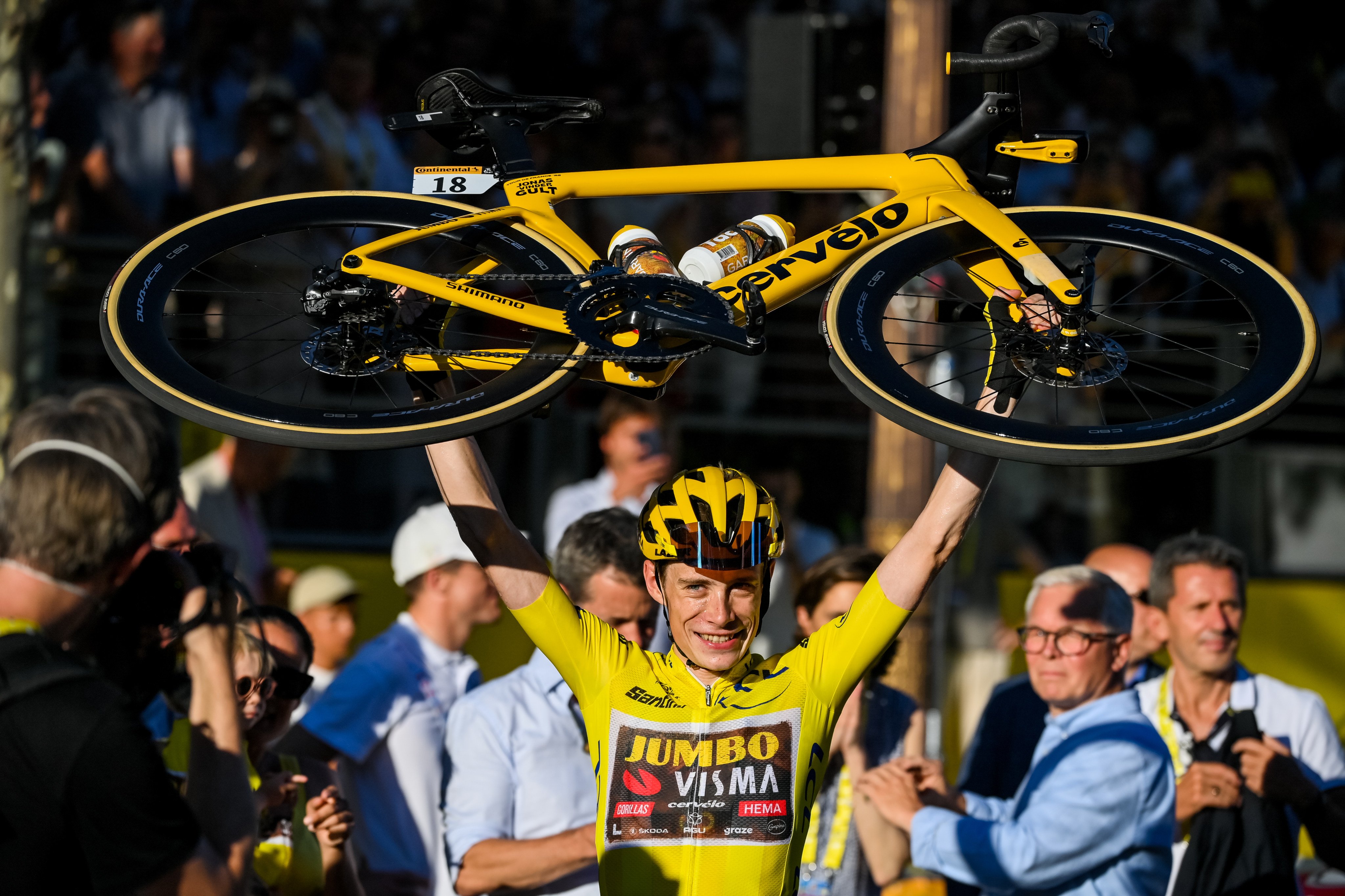 Danish rider Jonas Vingegaard raises his bicycle as he celebrates winning the 109th edition of the Tour de France cycling race in Paris, France on Sunday. Photo: dpa