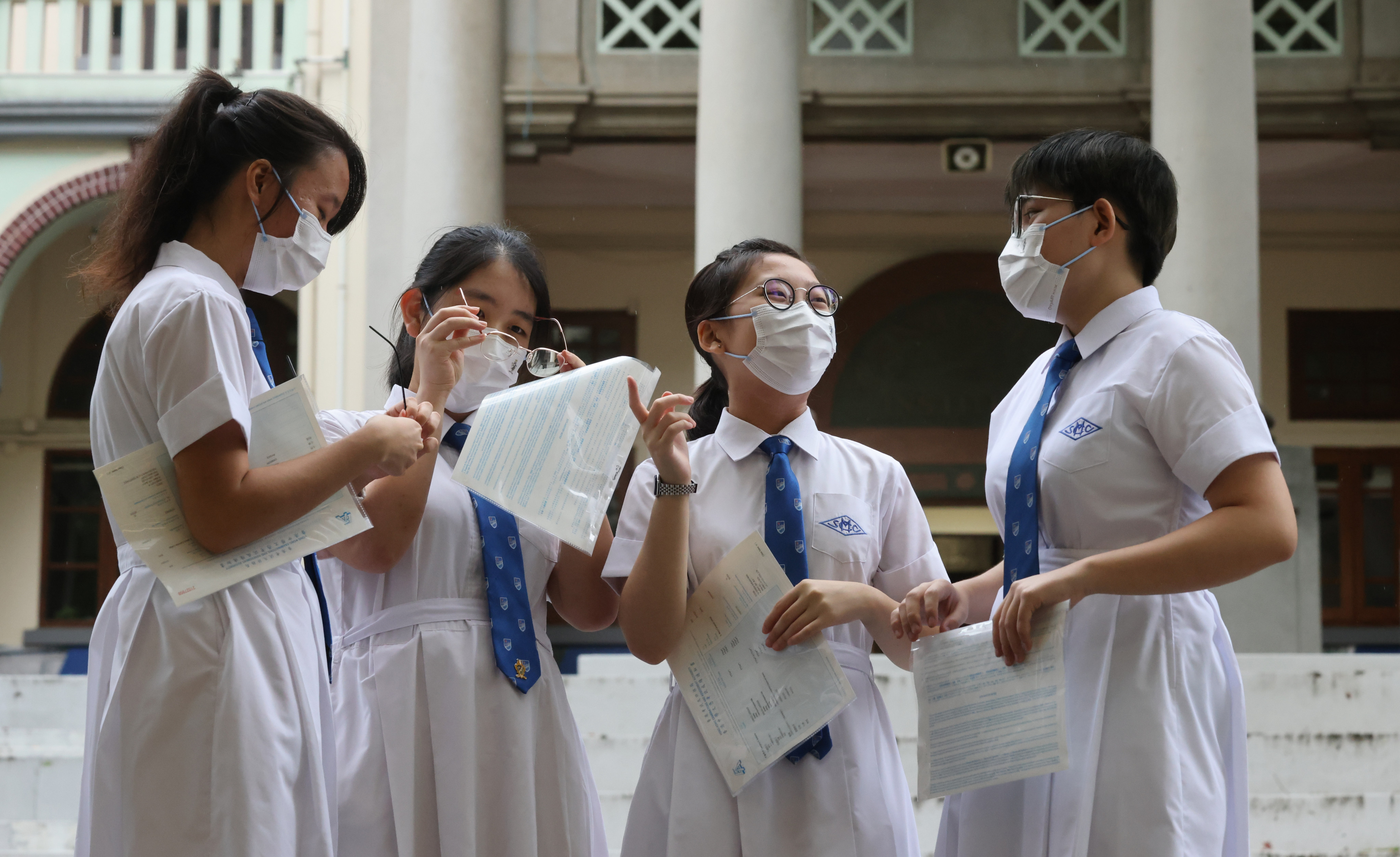 Students at St. Mary’s Canossian College (from left) Charmaine Hung Yuet-yi, Jenna Cheung Yan-ting, Serena Yu Sheung-wing and Jackie Wong Tsz-Li receive their Diploma of Secondary Education examination results on July 21. Photo: May Tse