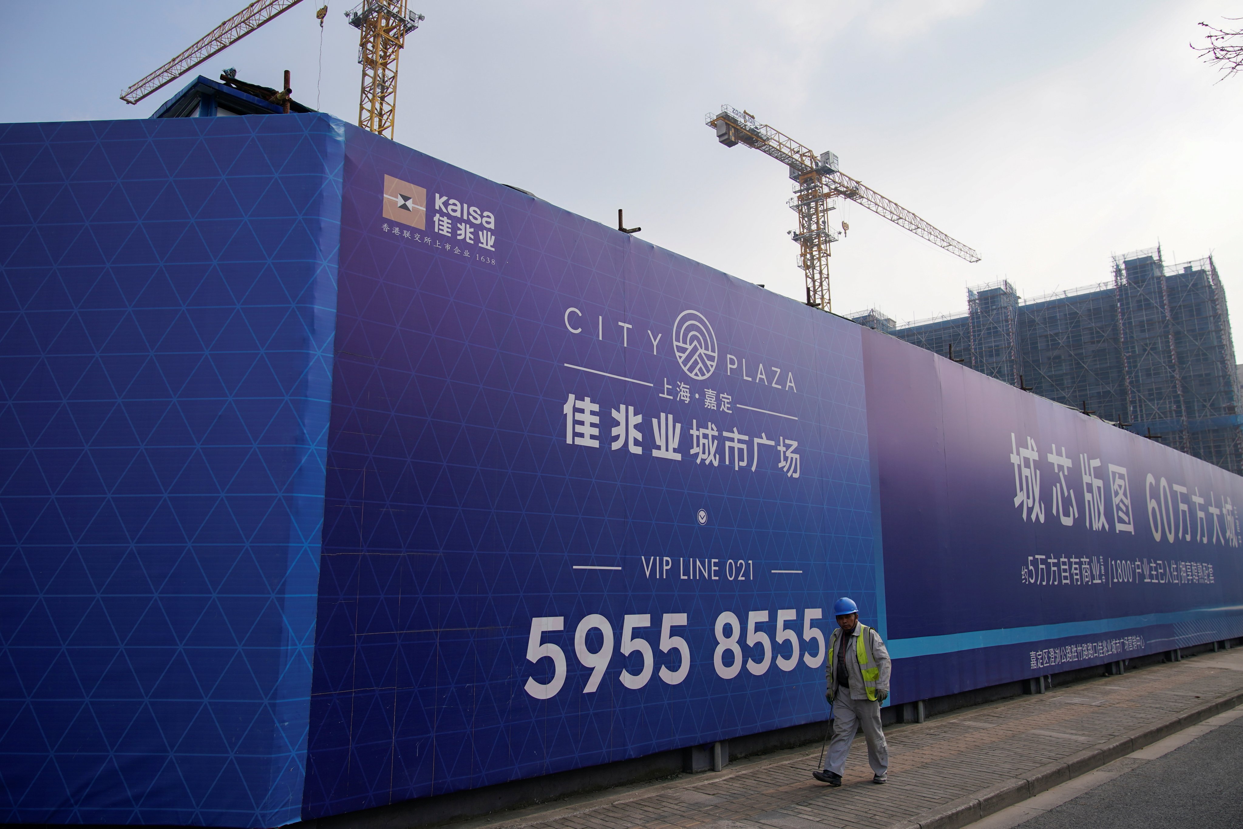 A worker walks past a construction site of Kaisa Group in Shanghai in December last year. Photo: Reuters
