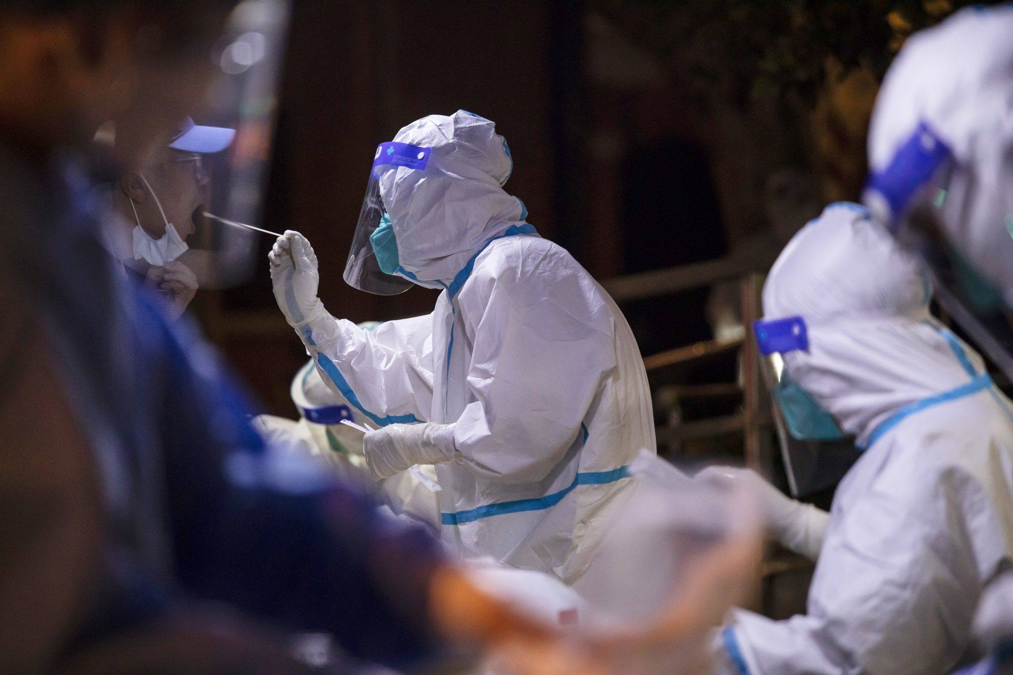 Health workers in Shanghai perform Covid-19 swab tests on July 7. Photo: Bloomberg