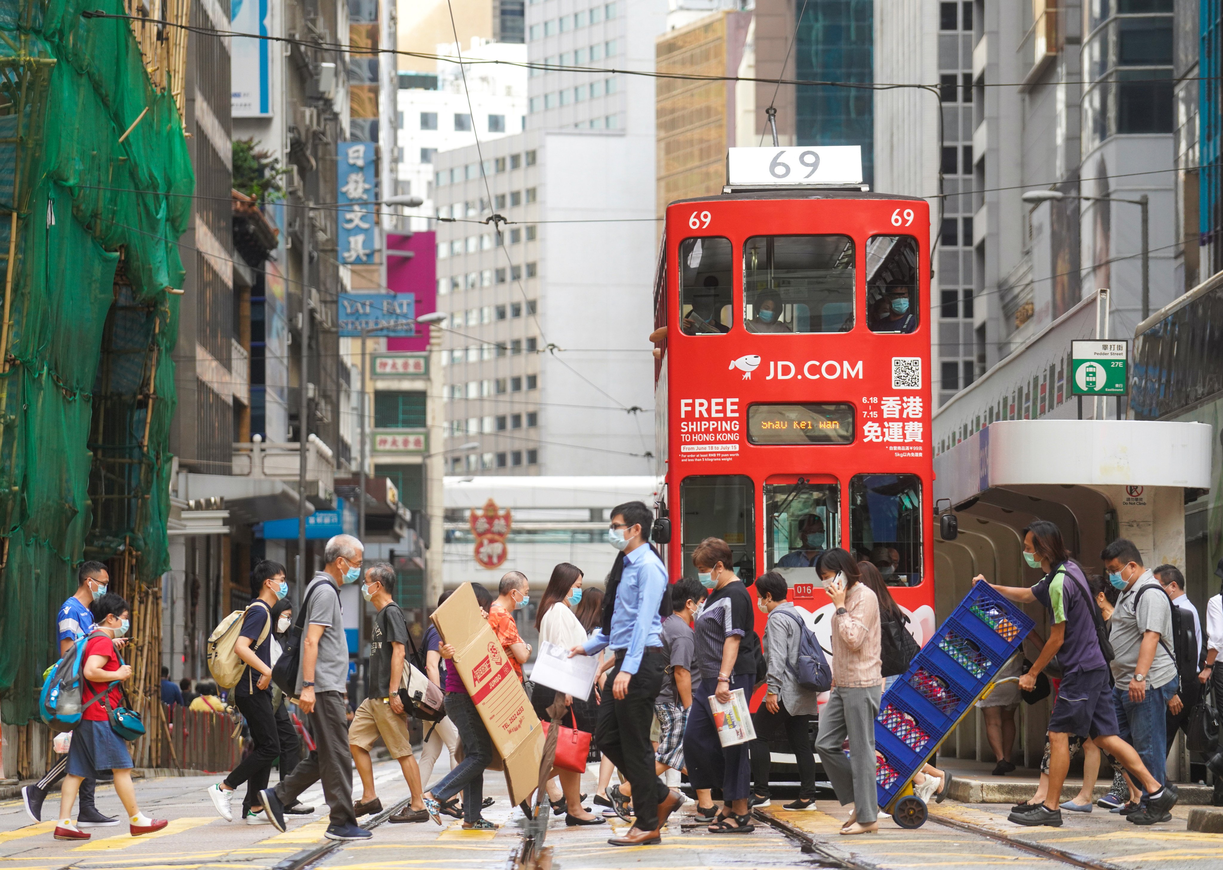 Pedestrians cross the road in Central in 2020. Other than a slogan of “walk more, ride less”, the latest Smart City Blueprint does not have a tangible proposal to reduce private car ownership and attendant pollution. Photo: Winson Wong 