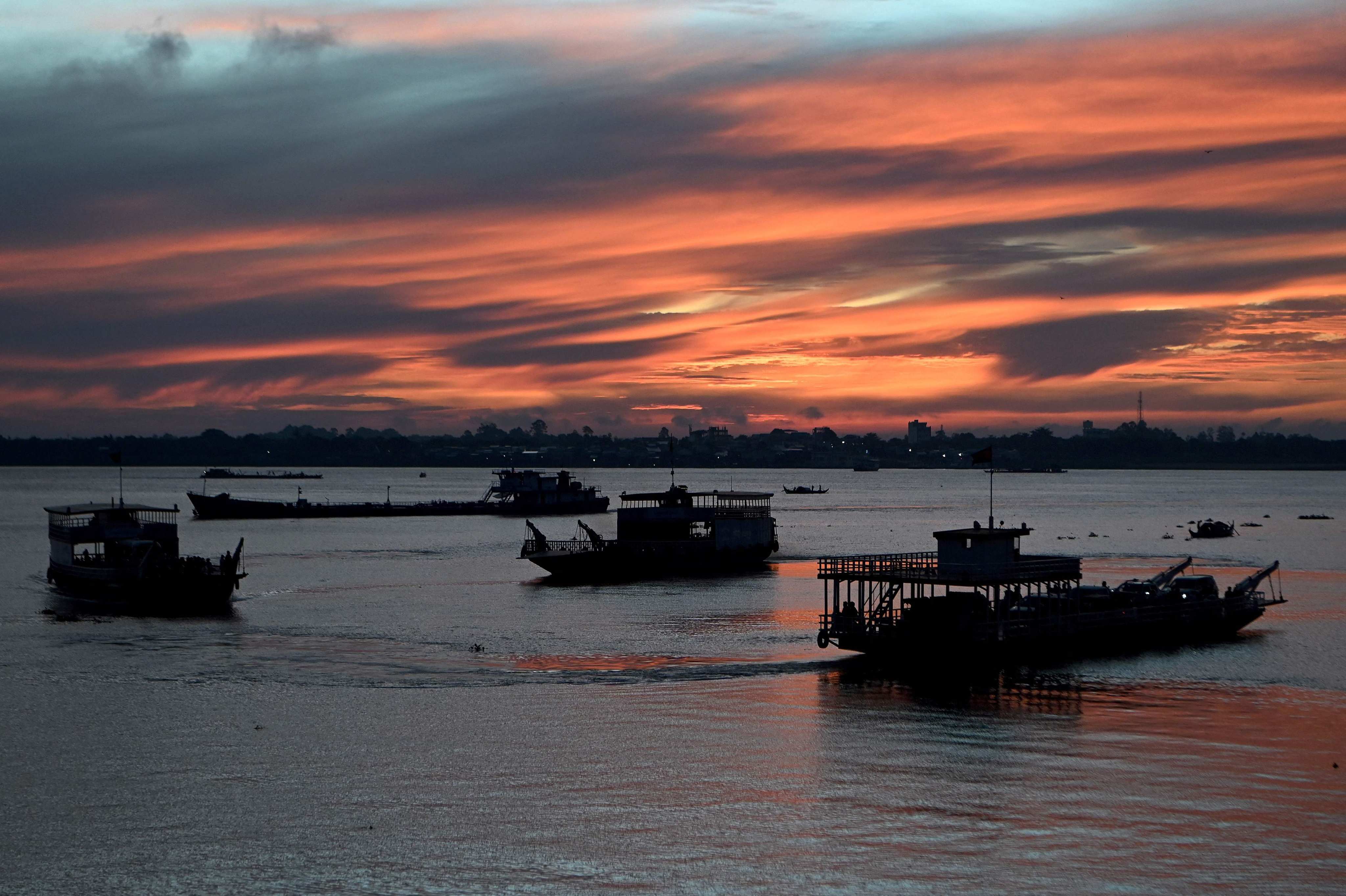 Ferries transport passengers and vehicles across the Mekong River in Phnom Penh. Cambodia’s policymakers are caught between the competing objectives of maintaining export development, stabilising the currency and safeguarding the livelihoods of low-income earners. Photo: AFP