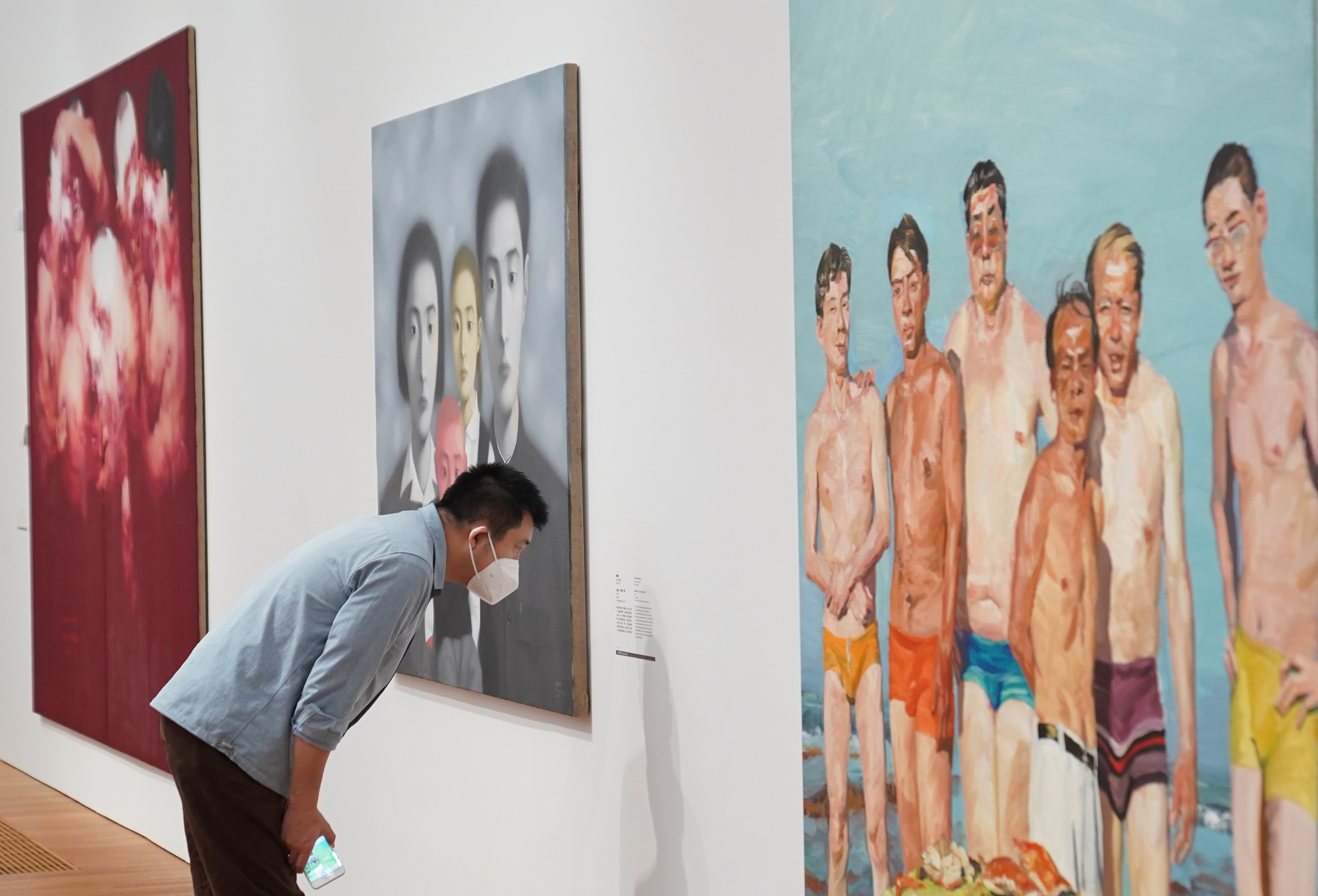 A visitor reads information about a painting at the M+ Museum in Hong Kong’s West Kowloon Cultural District. Photo: Sam Tsang