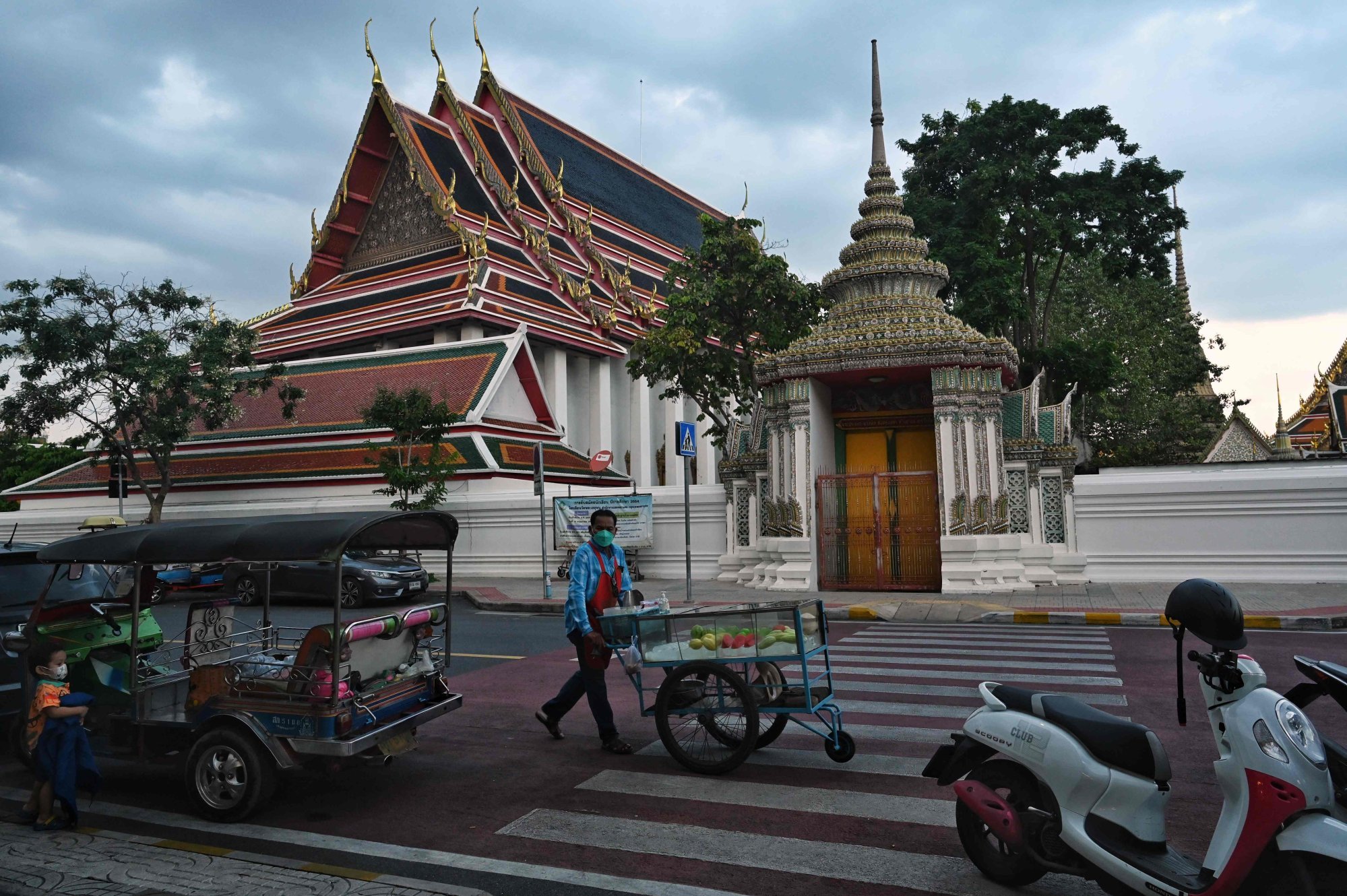 A fruit vendor wheels his wares near a popular tourist spot in Bangkok. File photo: AFP