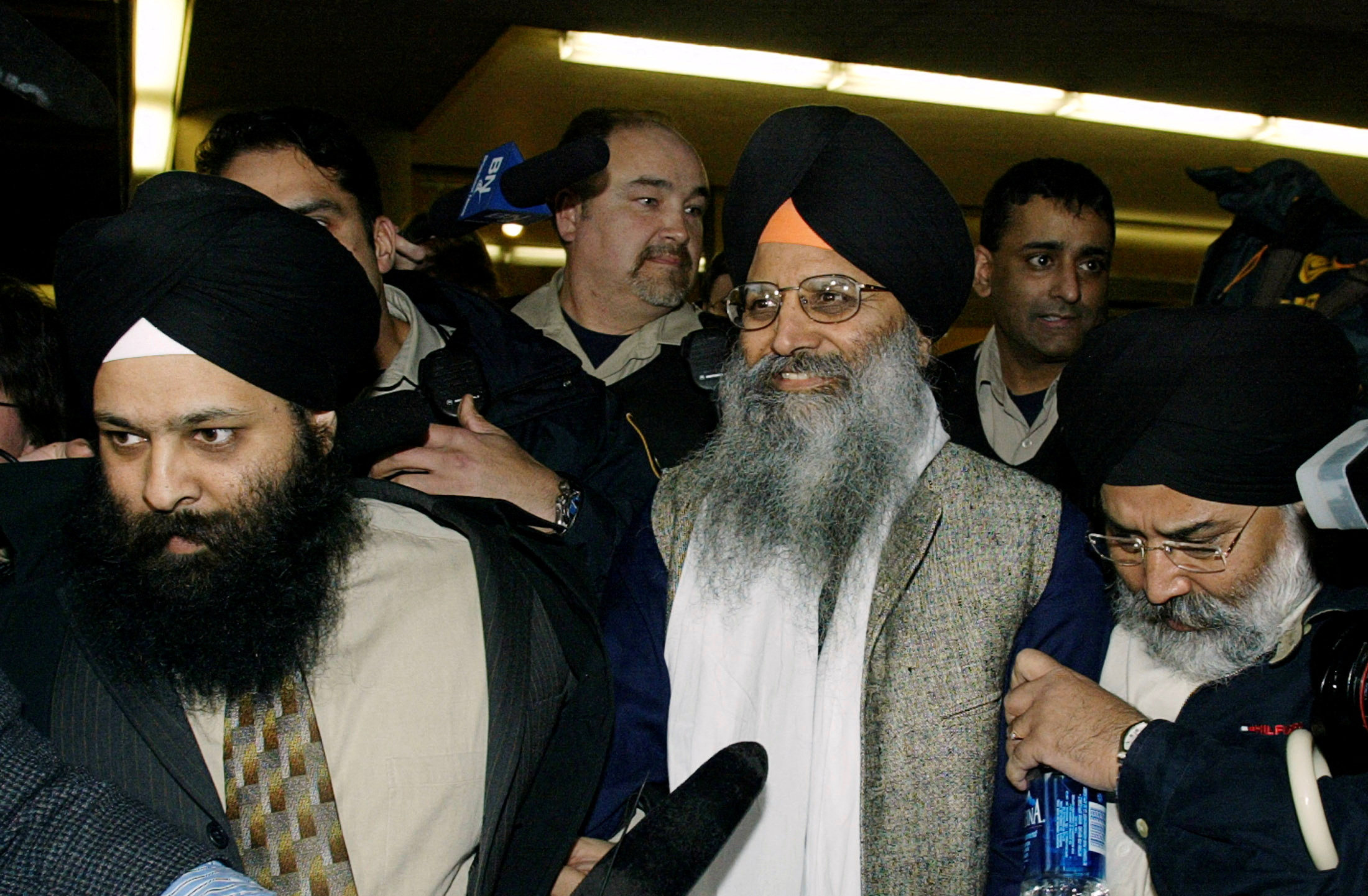 Ripudaman Singh Malik (centre) smiles as he leaves a Vancouver court in March 2005 after being found not guilty in the 1985 bombing of an Air India flight. Photo: Reuters