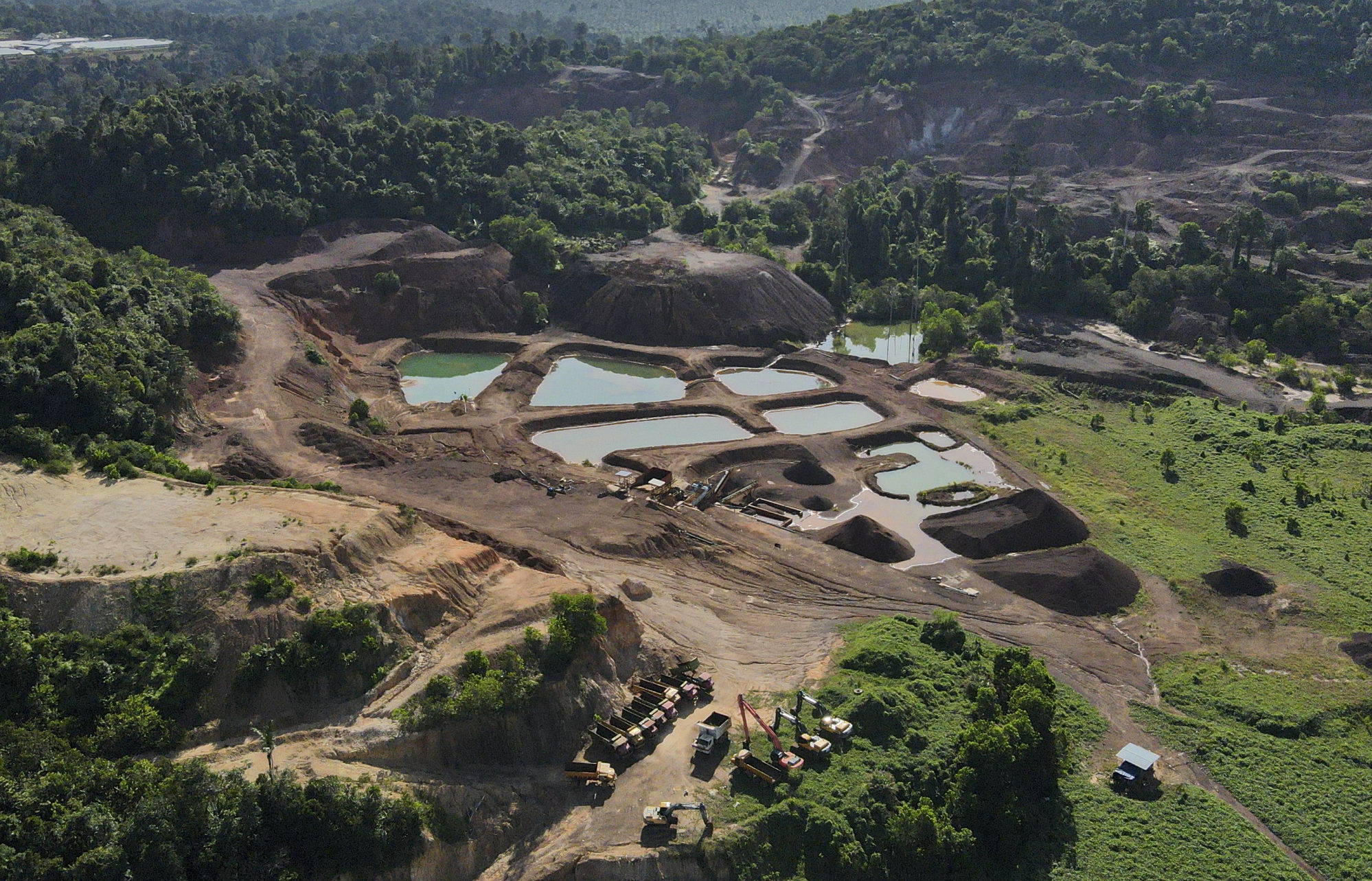 Mining pits and excavation vehicles are seen around Tasik Chini. Photo: Azneal Ishak