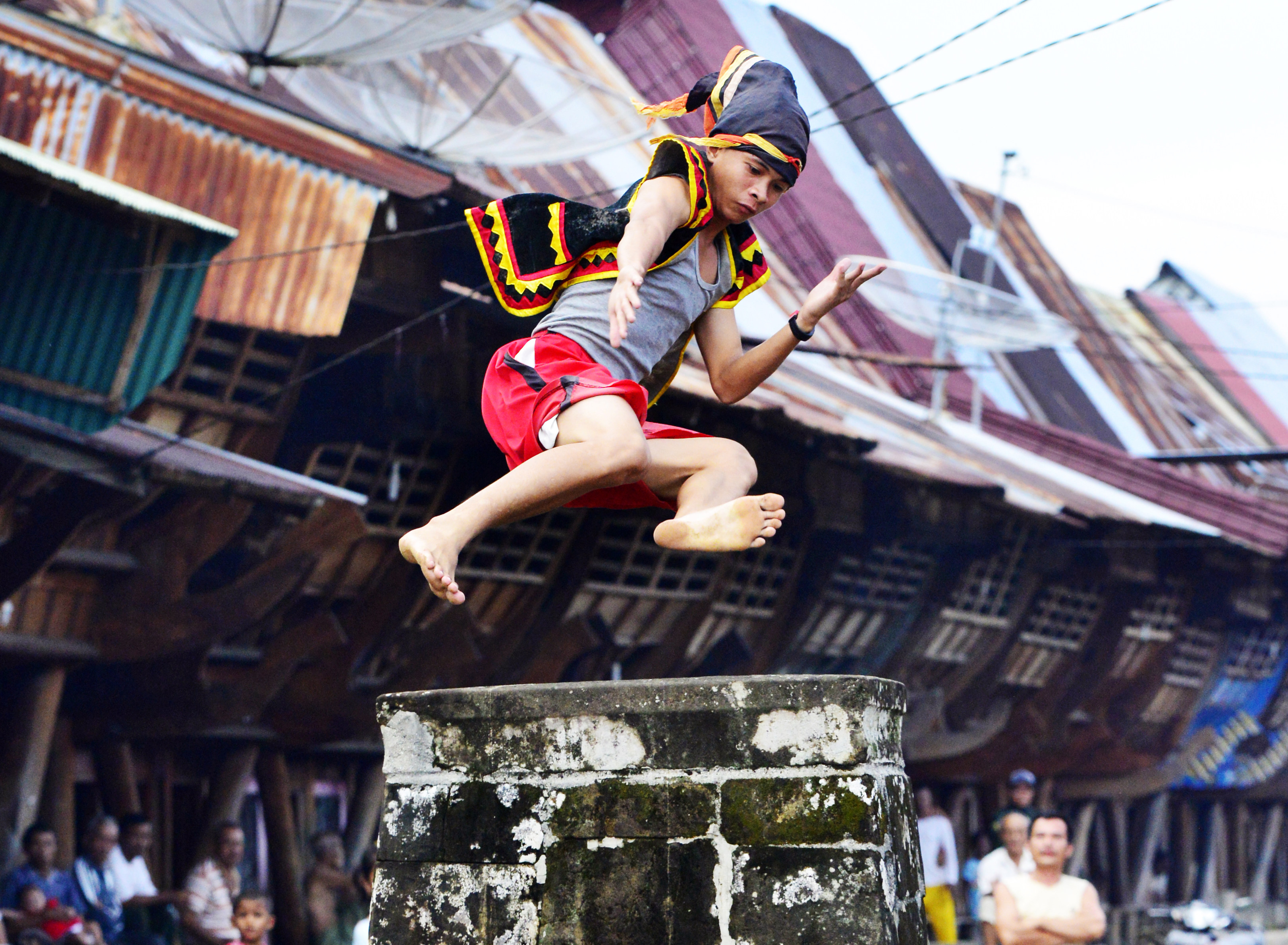 On the Indonesian island of Nias, young villagers jump over a stone pillar two metres tall. It is an example of the wealth of traditional cultures to be found beyond Bali and Java. Photo: Mark Eveleigh