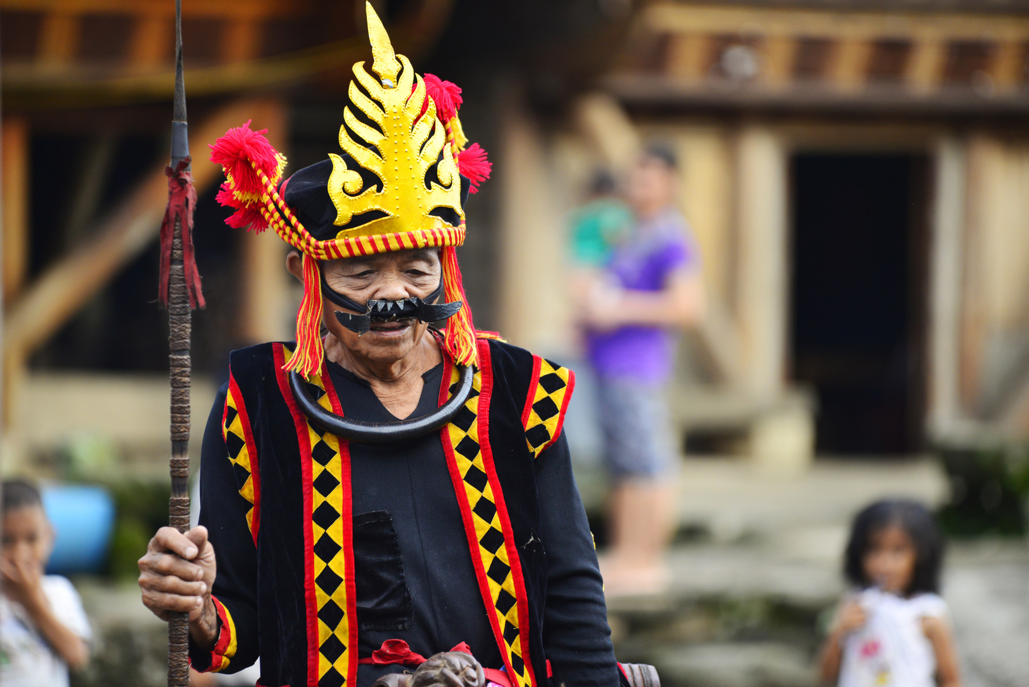 An old man in Hiliamaetaniha village, in the costume of a traditional Nias warrior. The fearsome mouthpiece was designed to intimidate enemies. Photo: Mark Eveleigh