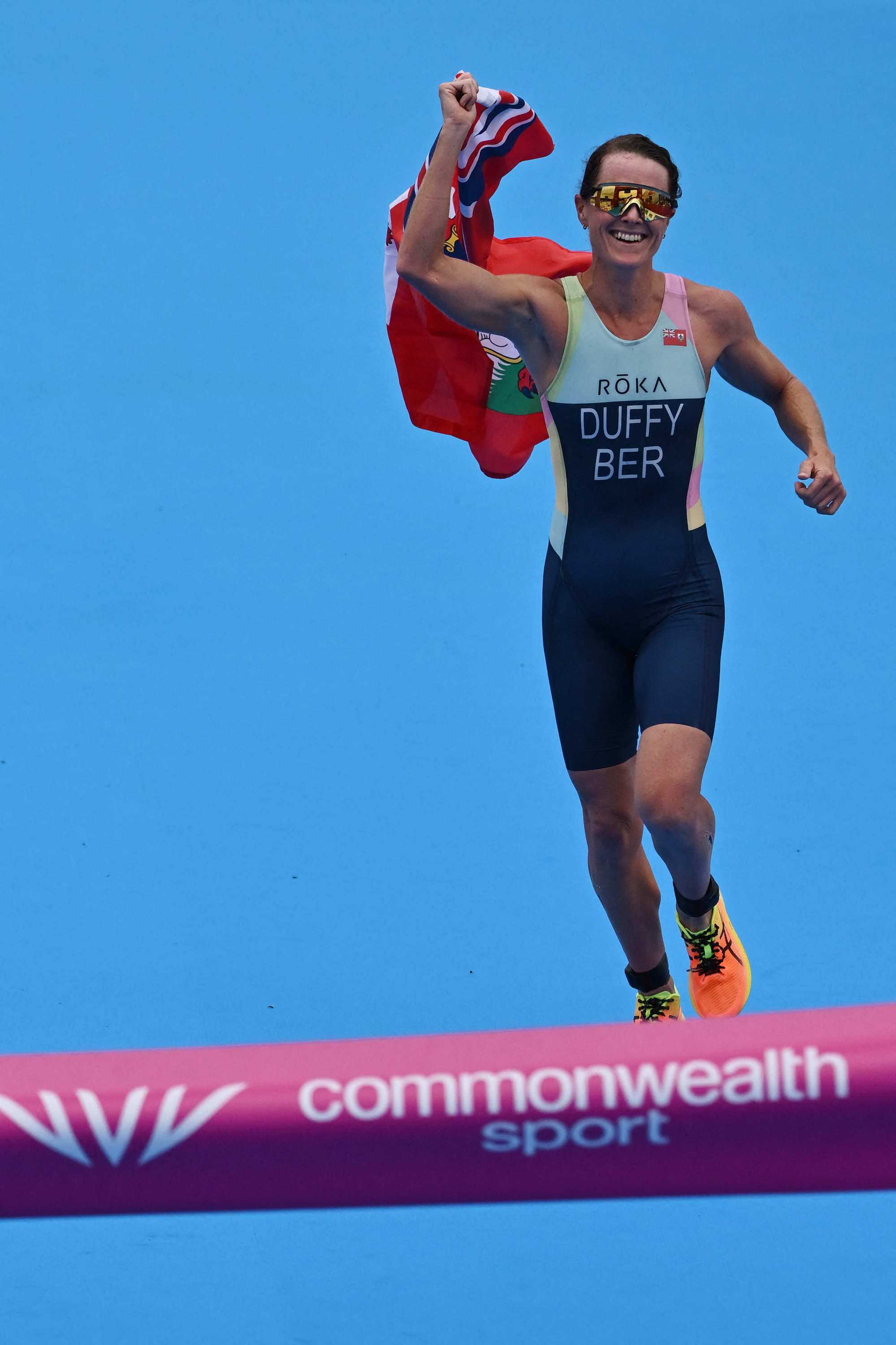 Bermuda’s Flora Duffy crosses the finish line to win and take the gold medal in the women’s individual triathlon. Photo: AFP