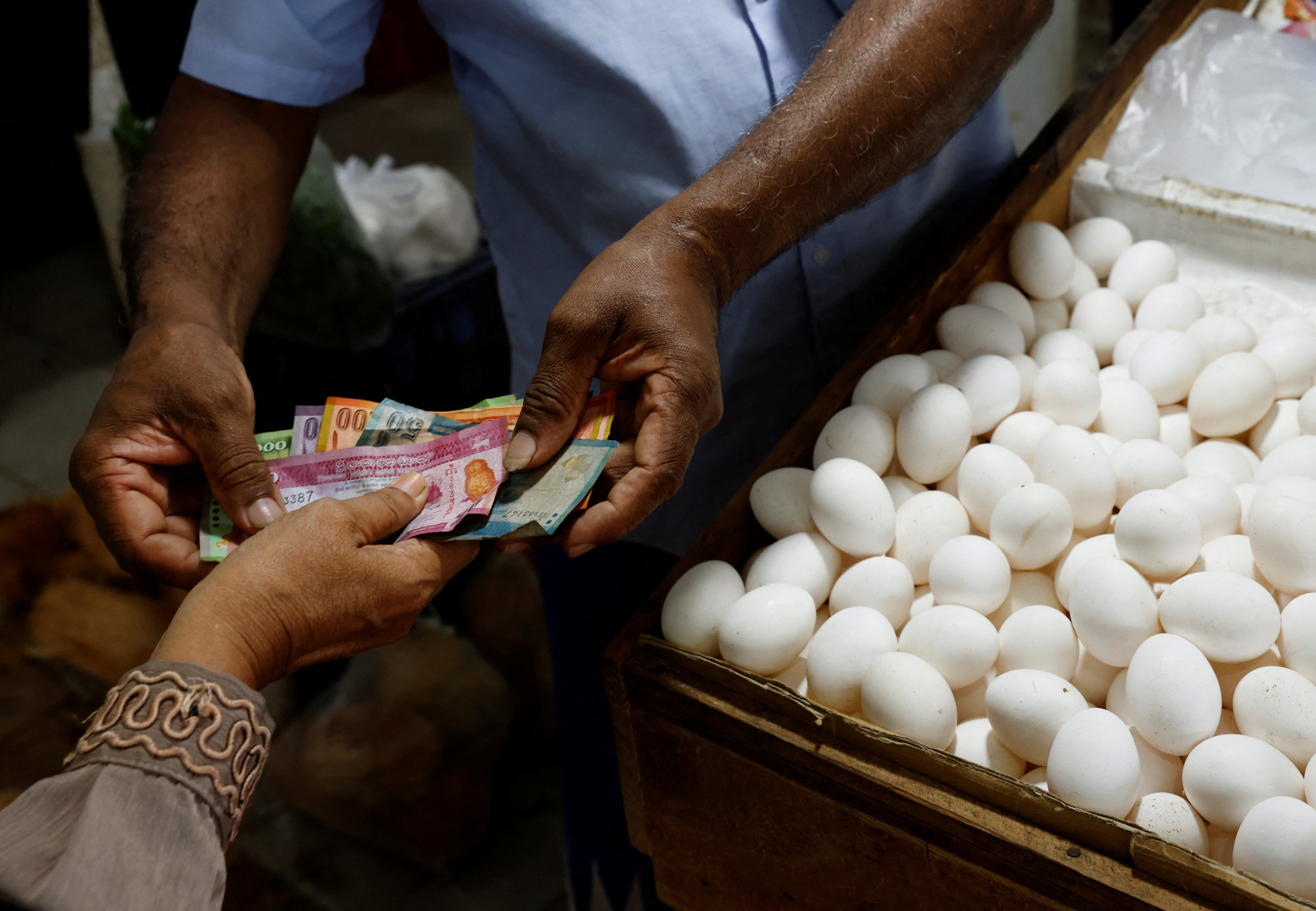 A vendor gives change to a customer after selling eggs amid the rampant food inflation, amid Sri Lanka’s economic crisis, in Colombo, Sri Lanka on Friday. Photo: Reuters