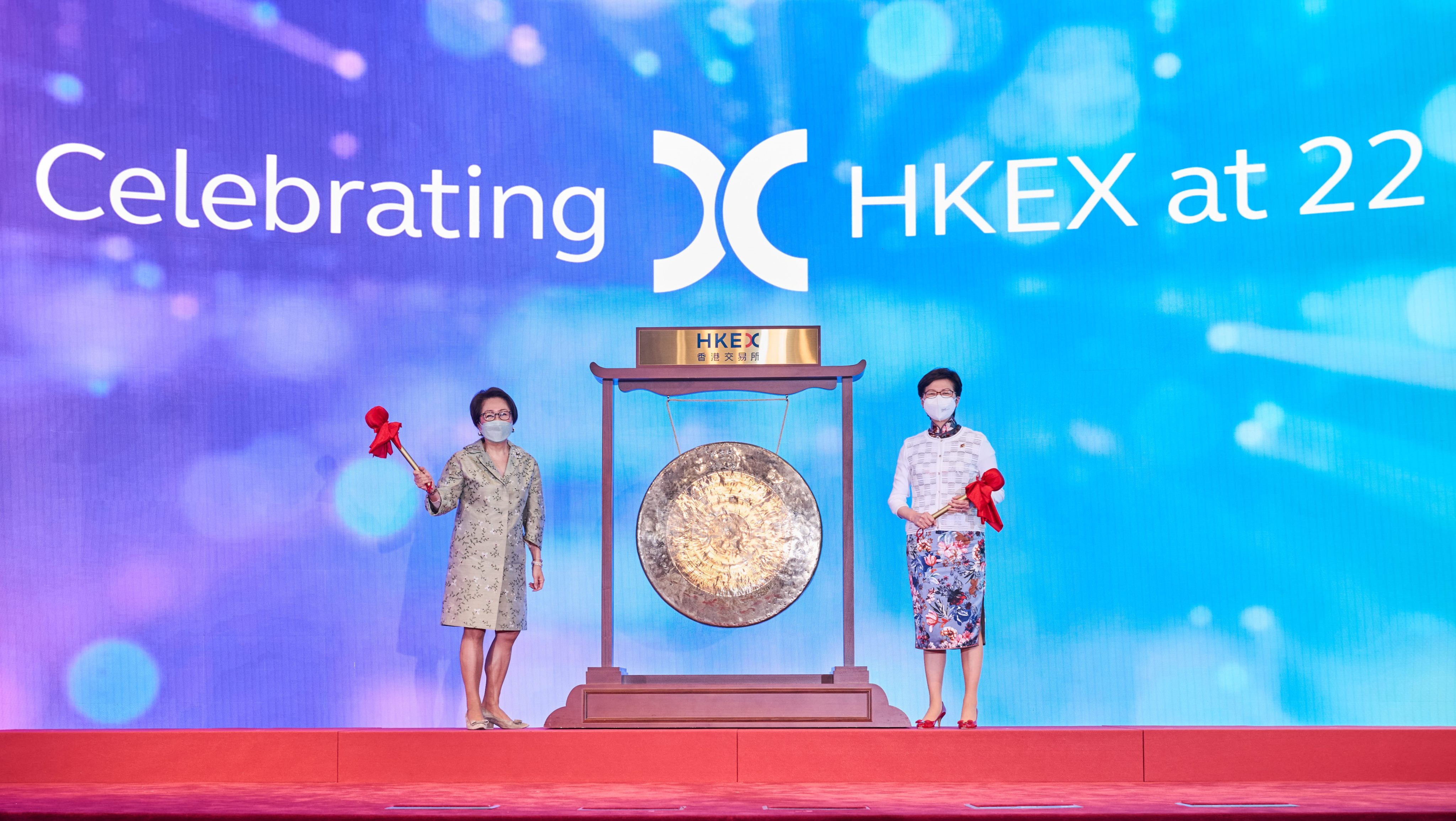 Hong Kong Exchanges and Clearing chairwoman Laura Cha Shih May-lung (left) and then chief executive Carrie Lam Cheng Yuet-Ngor strike the gong to mark HKEX’s 22nd anniversary as a listed company on June 21. Photo: HKEX