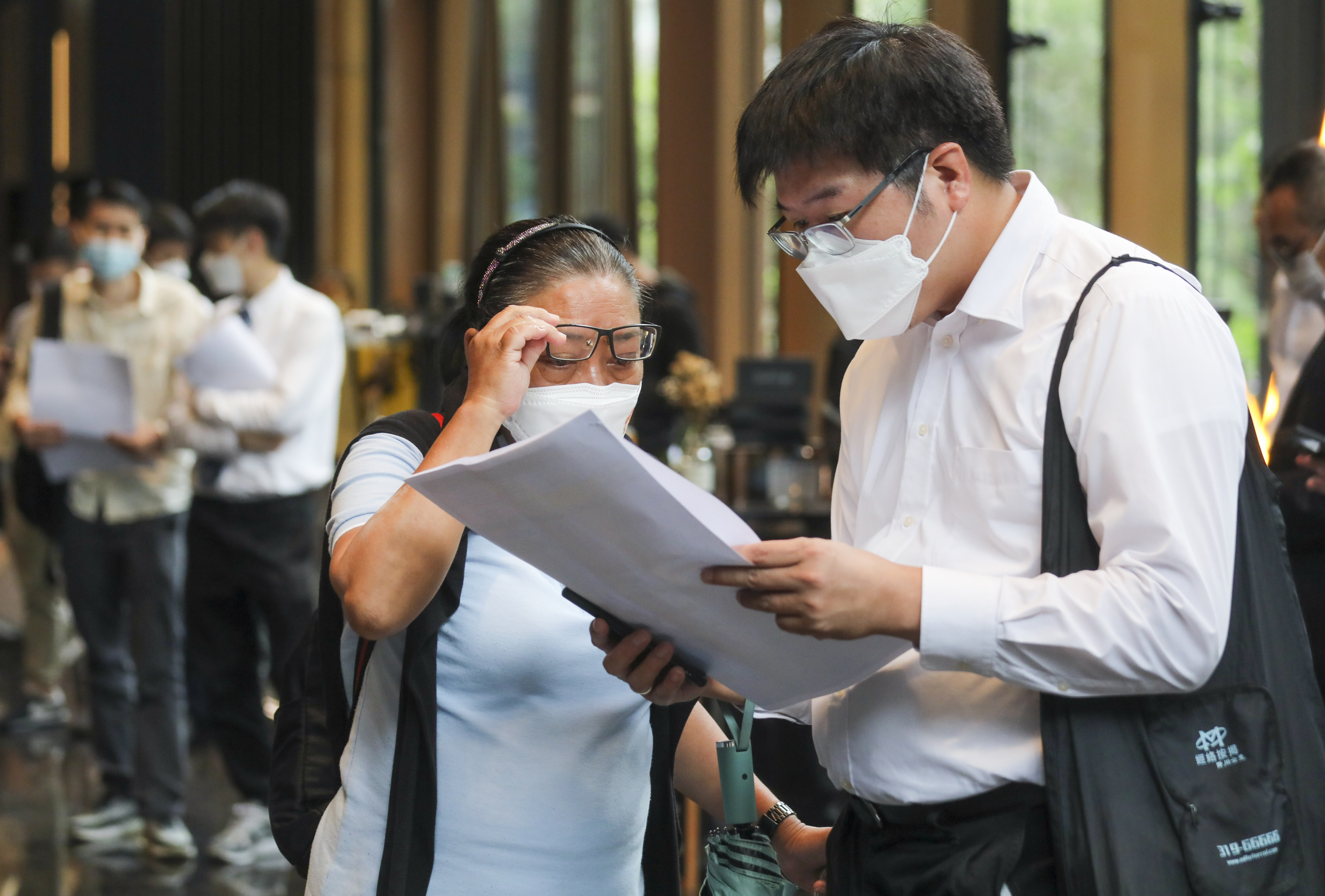 Potential buyers consider flats at Centralcon Properties’ The Aries development at Kingston International Centre in Kowloon Bay on May 27, 2022. Photo: SCMP / Xiaomei Chen