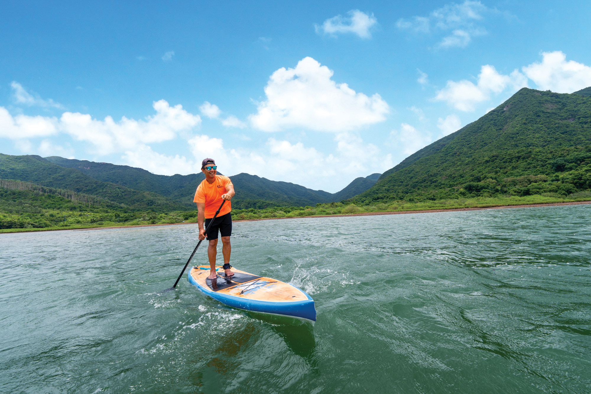 Stand-up paddleboard coach Edmund Lai says the activity is a great way for people to connect with Mother Nature.