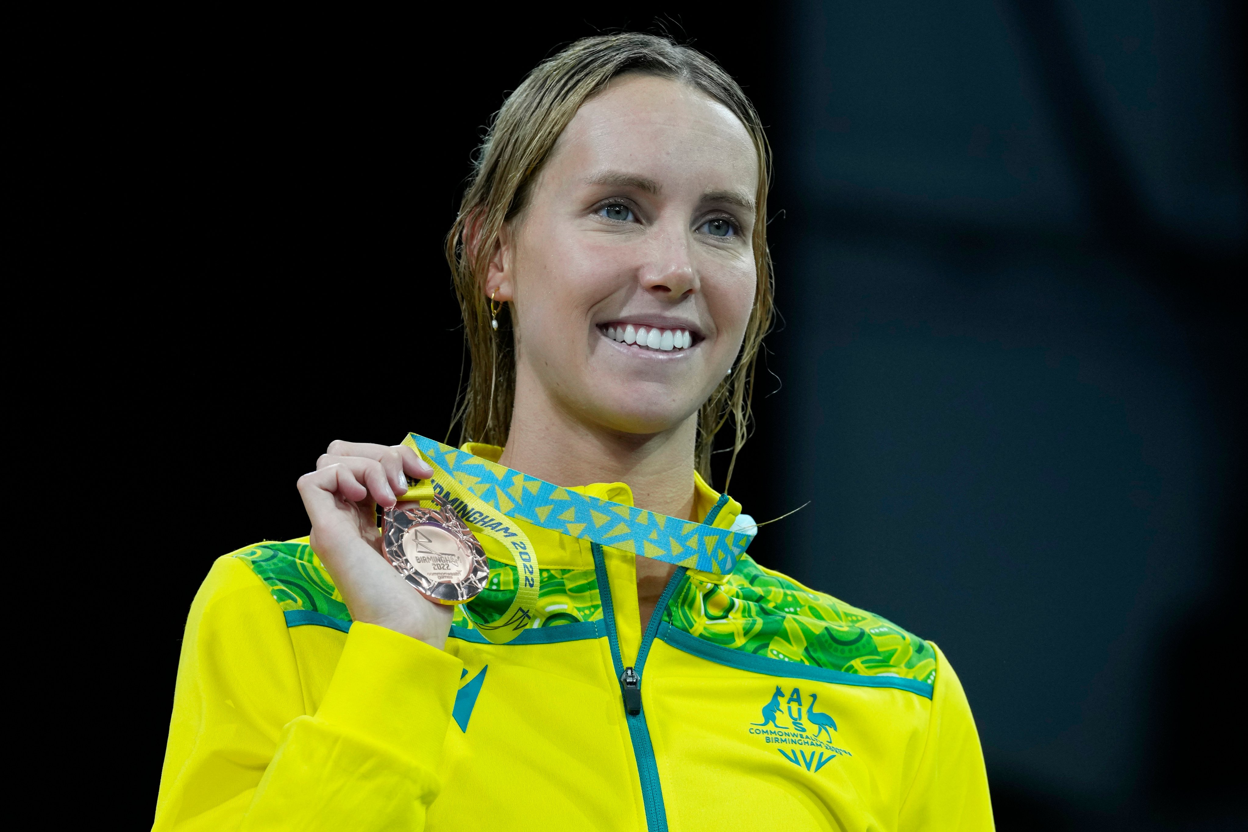 Australia’s Emma McKeon celebrates during a medal ceremony for the women’s 100m freestyle at the Commonwealth Games. Photo: AP