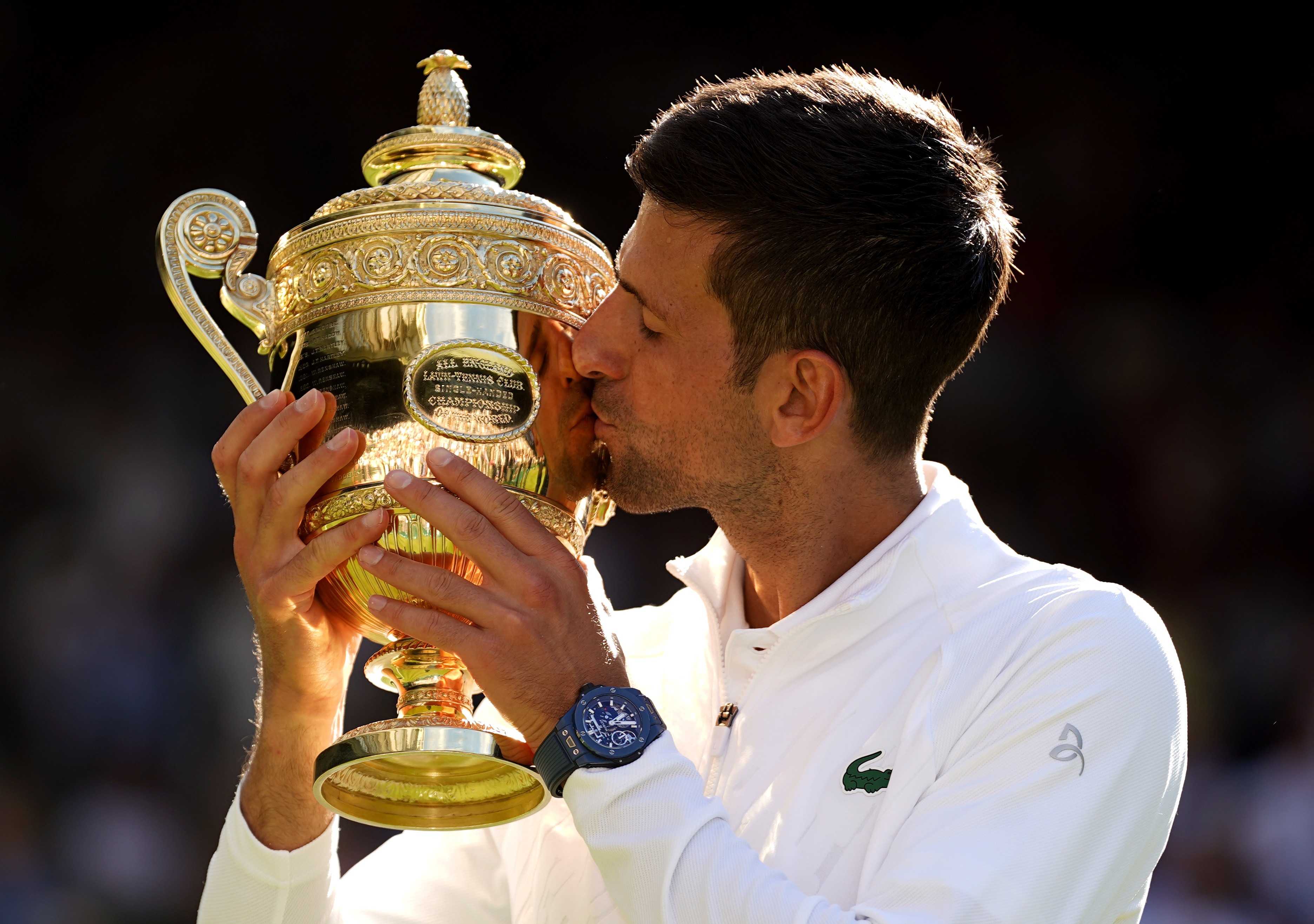 Novak Djokovic celebrates with the Wimbledon trophy after defeating Australia’s Nick Kyrgios in their men’s singles final match at the All England Lawn Tennis and Croquet Club in London on July 10. Photo: PA Wire/dpa