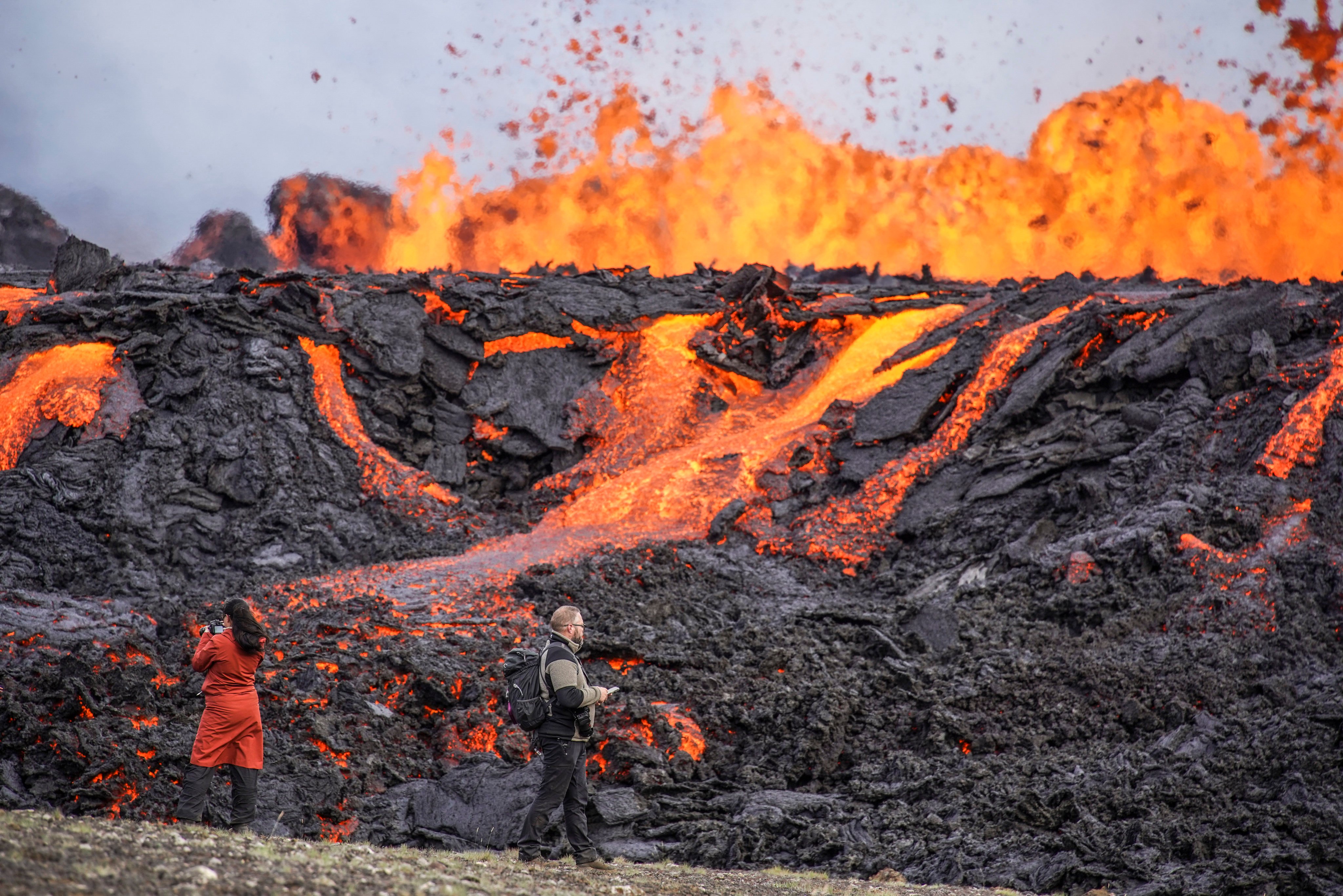 People look at the lava flowing on Fagradalsfjall volcano in Iceland on Wednesday. Photo: AP
