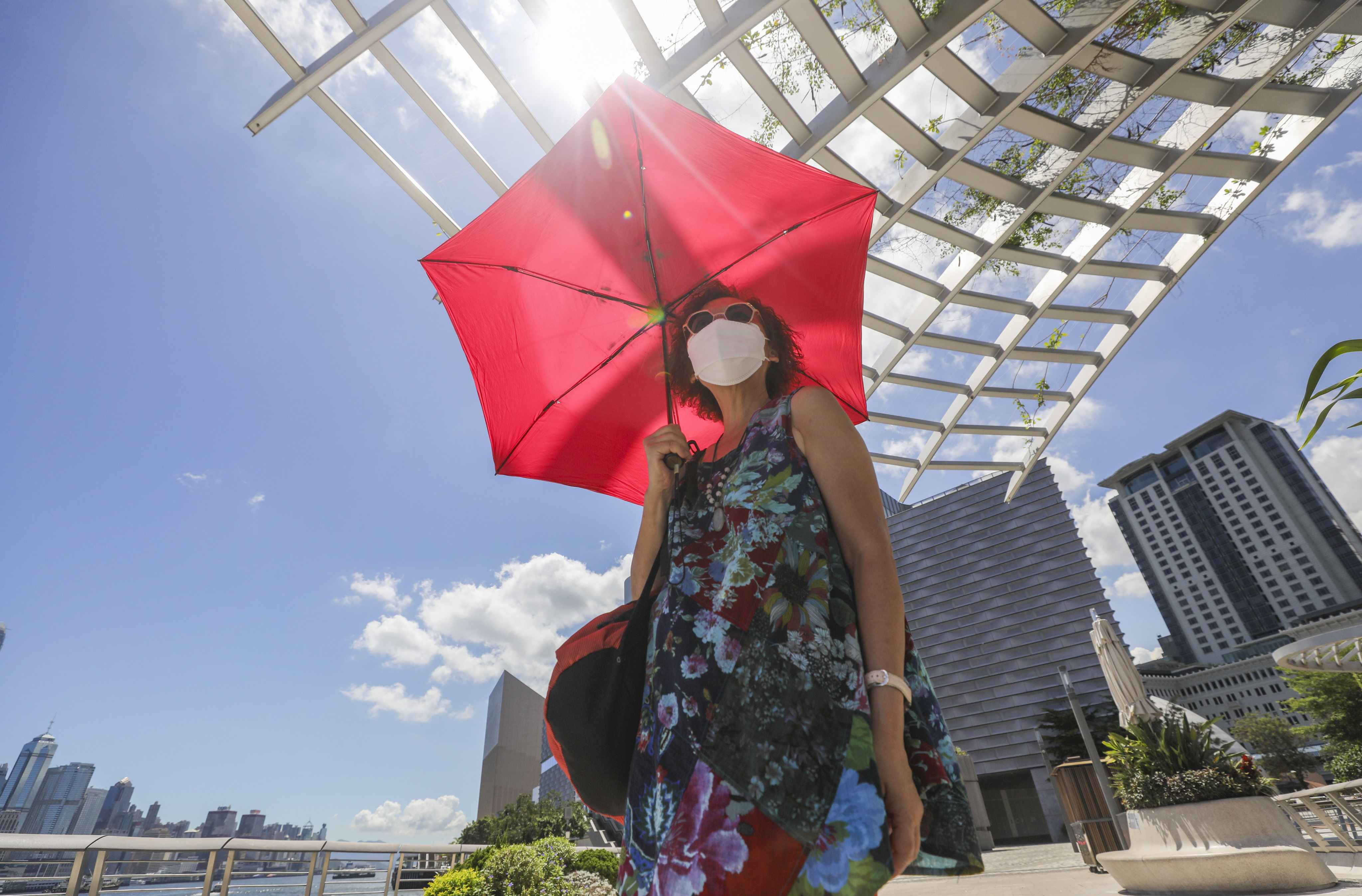 A woman shelters from the sun in Tsim Sha Tsui on July 12, after a very hot weather warning was issued by the Hong Kong Observatory. Photo: Xiaomei Chen