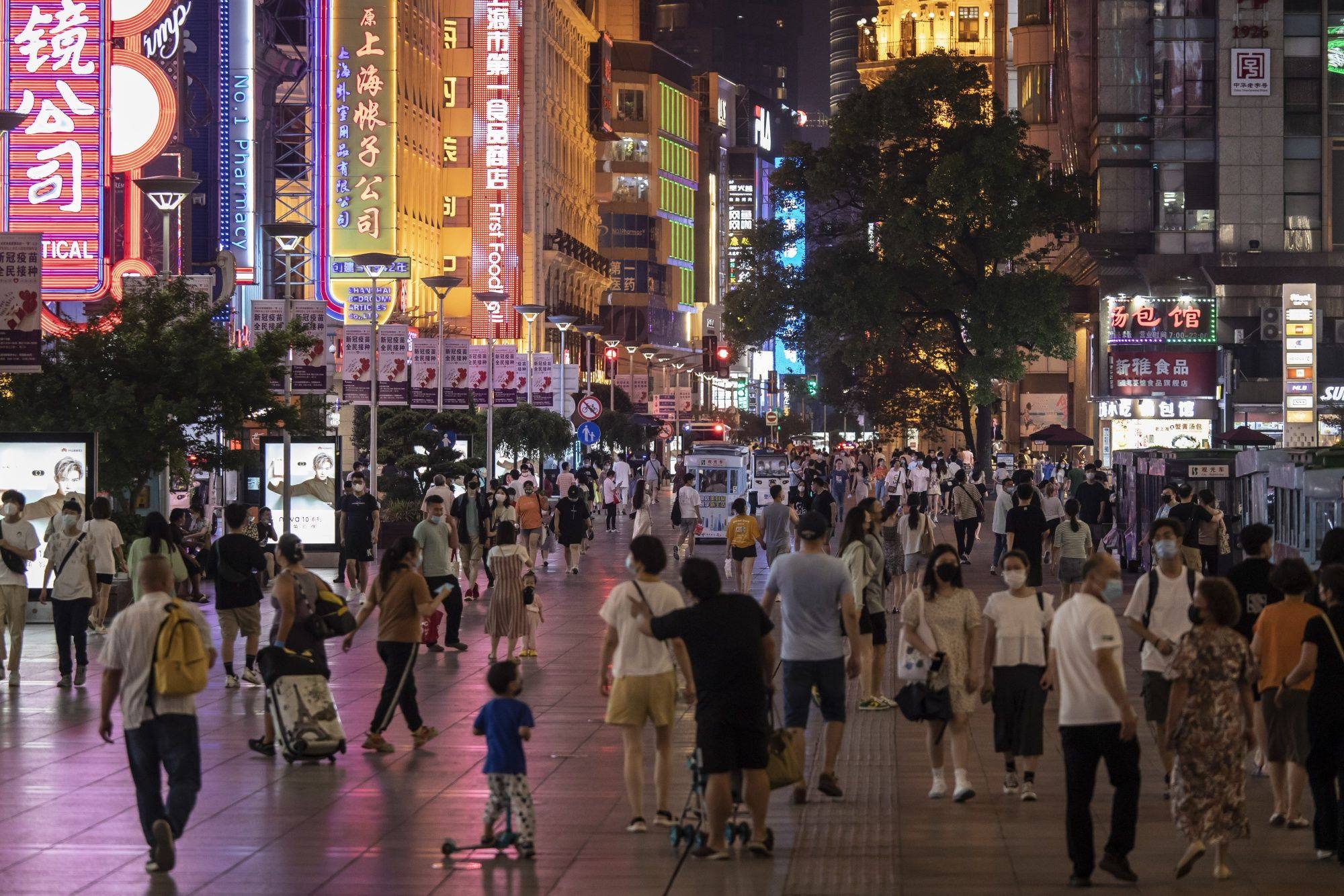 People walk along Nanjing Road, Shanghai’s famous shopping street. Photo: Bloomberg.