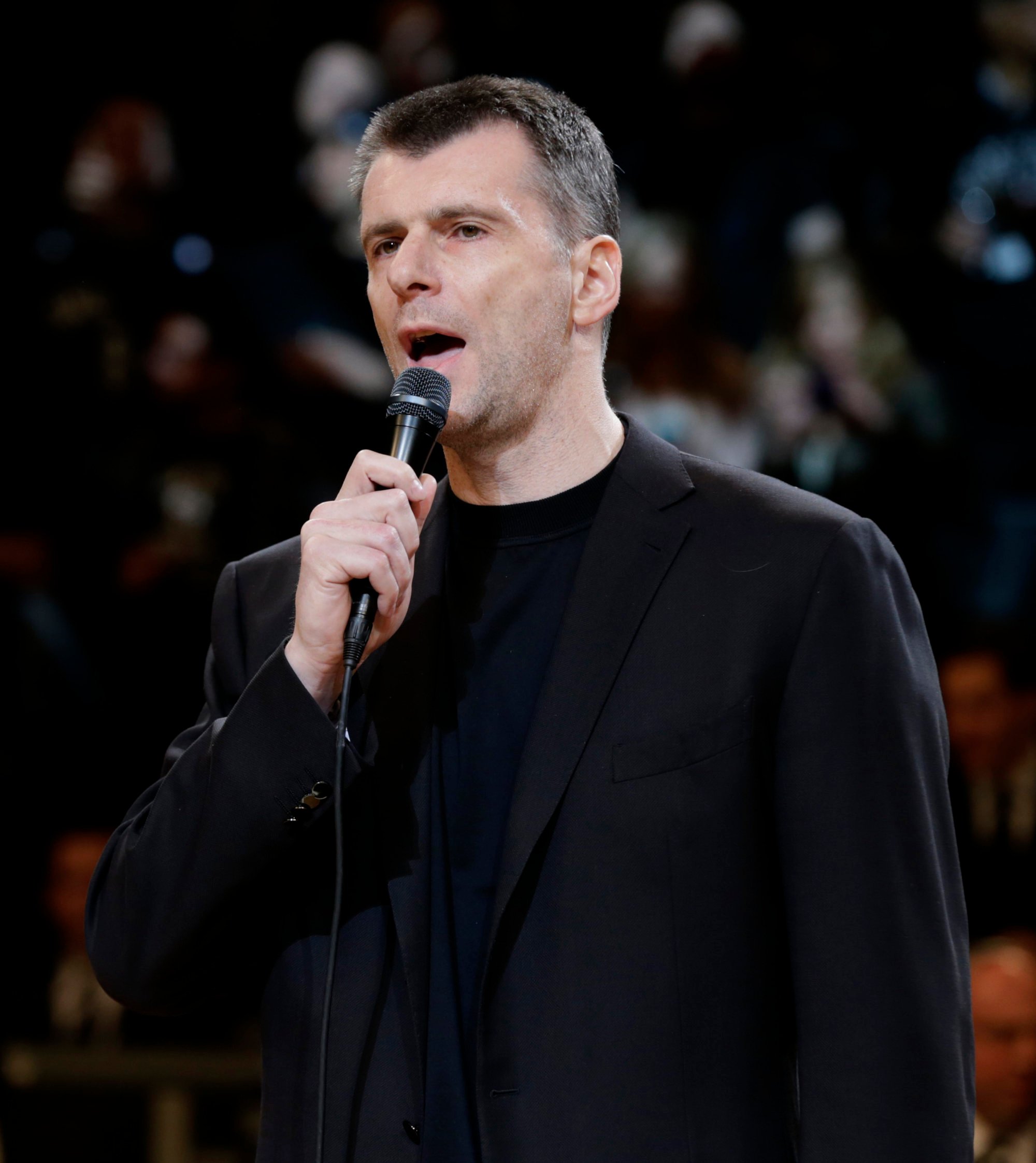 Brooklyn Nets owner Mikhail Prokhorov talks to the crowd before a playoff game against the Chicago Bulls in April 2013 in New York. Photo: AP
