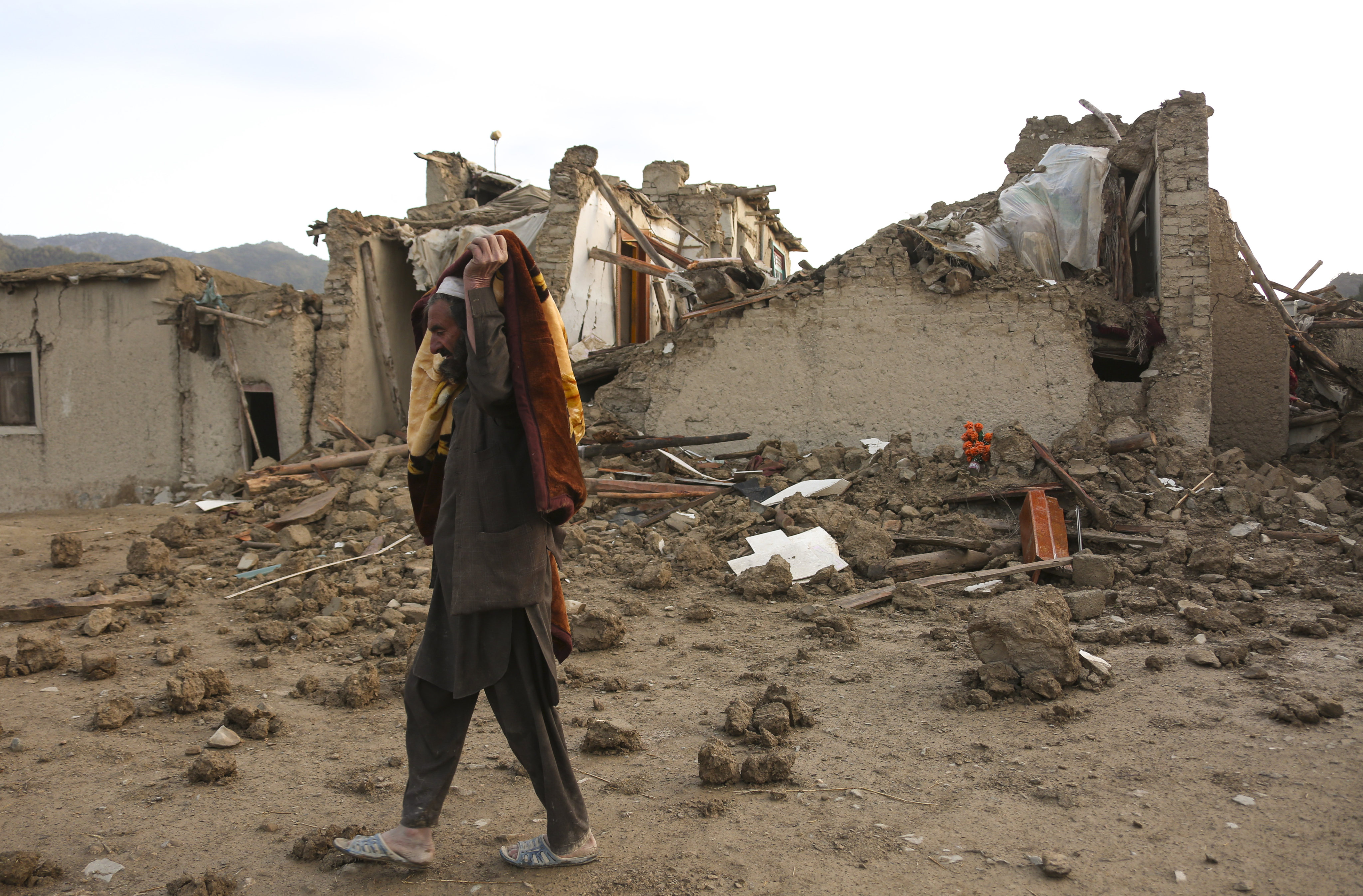 A man walks past houses damaged in an earthquake in Afghanistan’s Paktika province on June 23. Photo: Xinhua