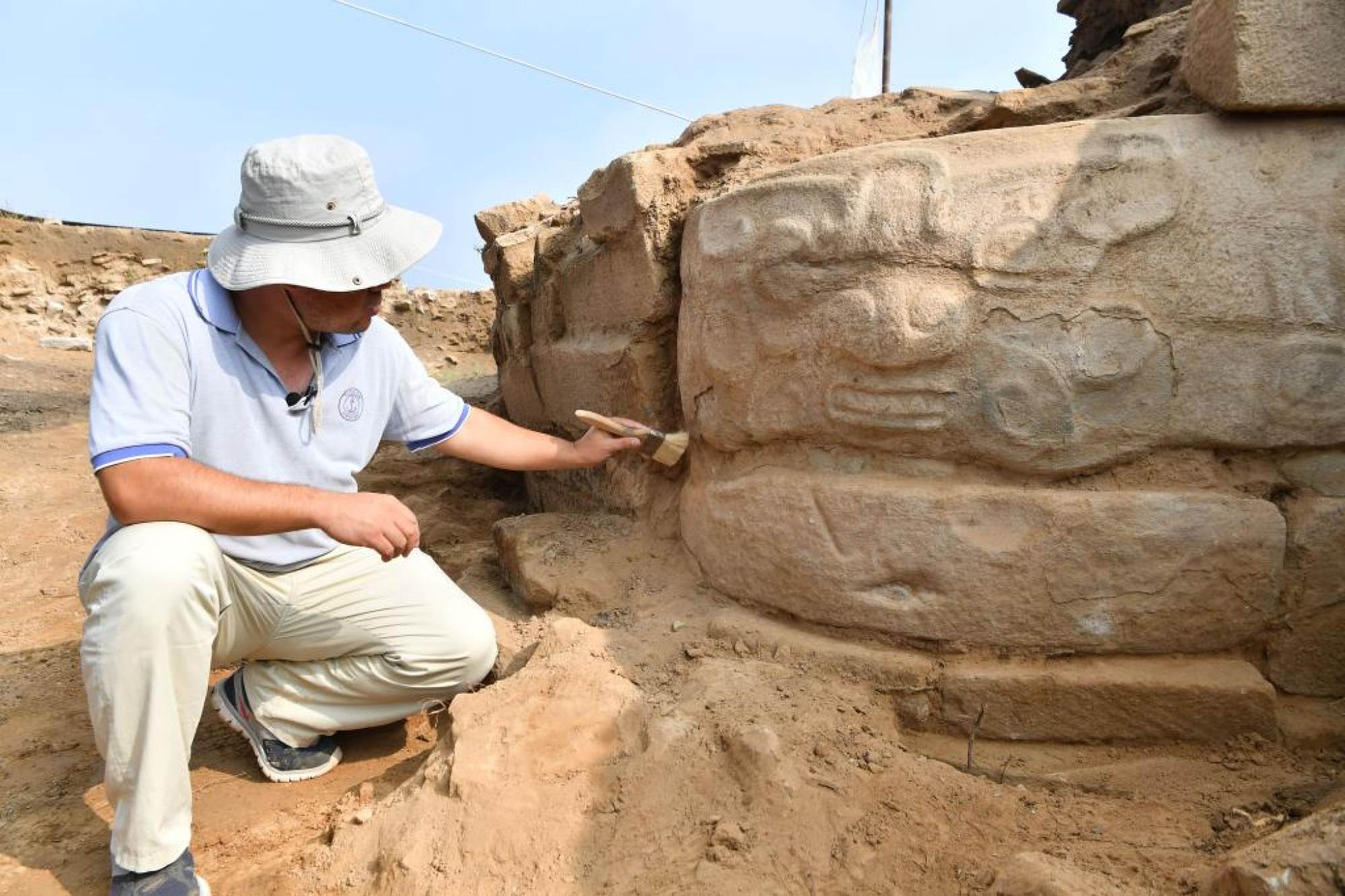 Archaeologists have unearthed two of three faces in a 2-metre stone sculpture. Photo: Handout