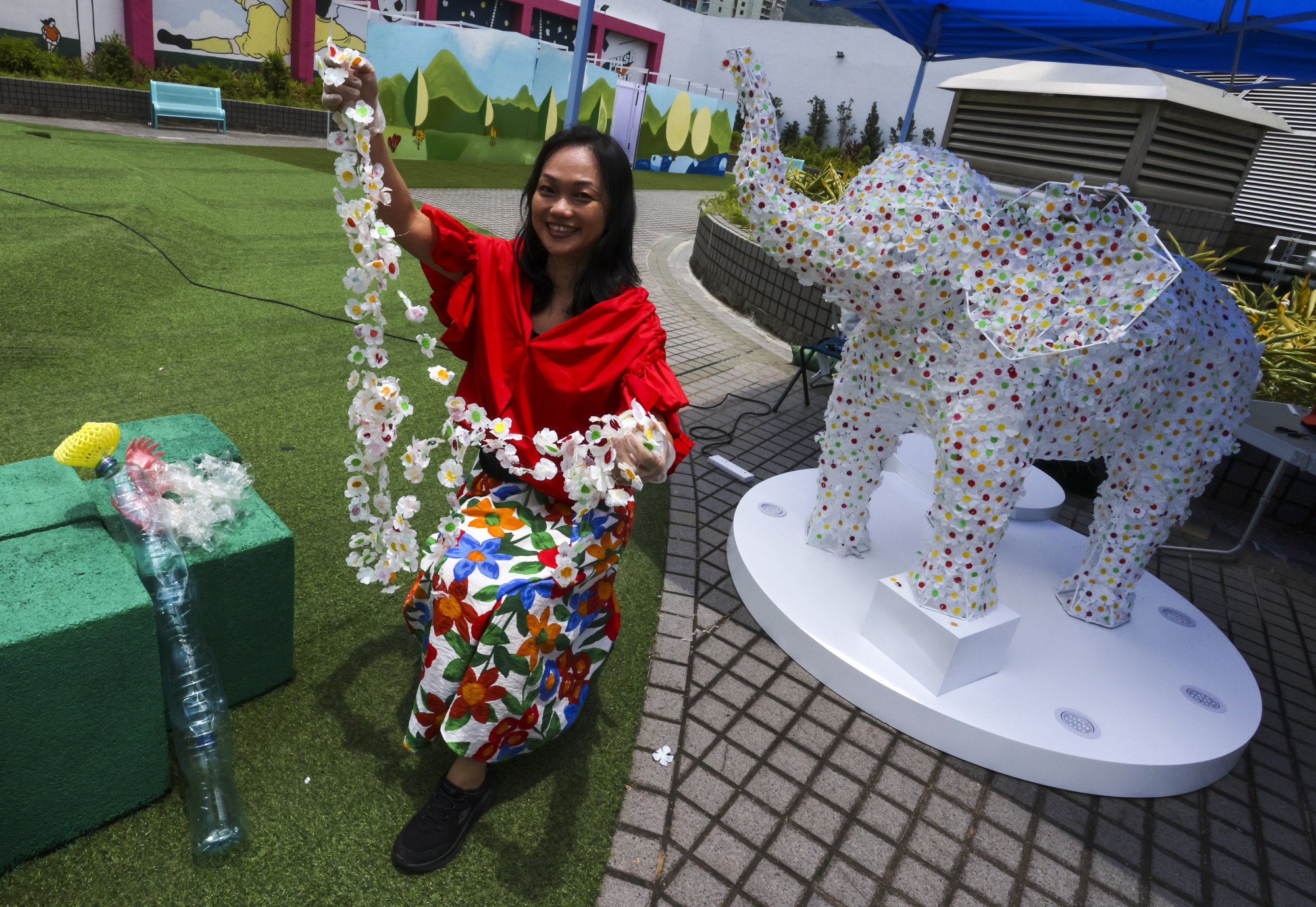 Pang with her elephant sculpture. With an MBA, a law degree and a background in corporate marketing, she doesn’t come from a typical art background. Photo: Jonathan Wong