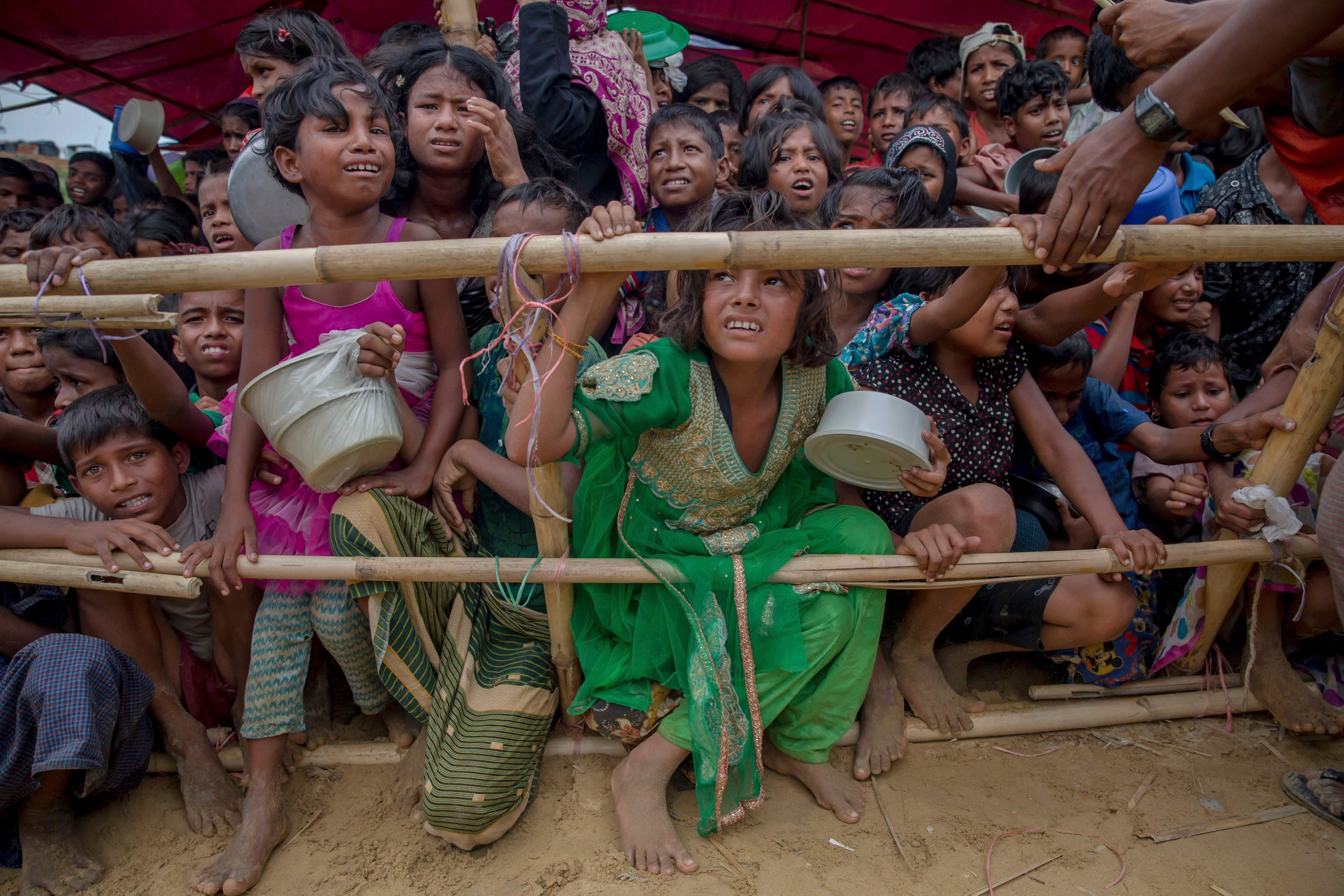 Rohingya children wait for food handouts after crossing over from Myanmar to Bangladesh as refugees in 2017. Photo: AP