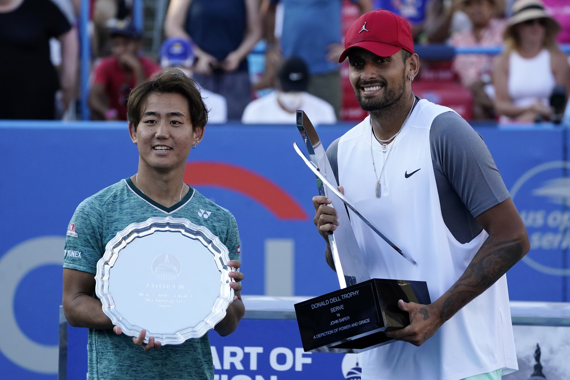 Nick Kyrgios (right) and Yoshihito Nishioka collect their prizes after the former’s victory in the final in Washington. Photo: EPA-EFE