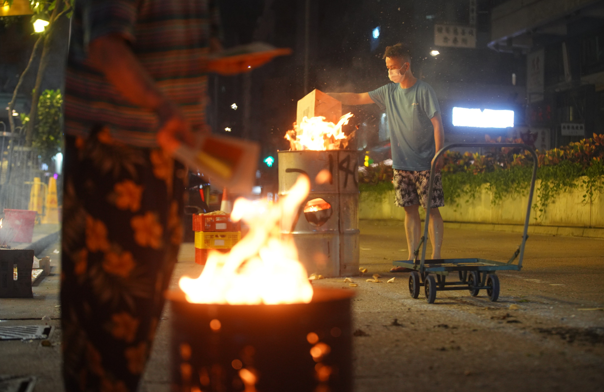 A man burns paper offerings during the Hungry Ghost Festival in Hong Kong’s Wan Chai neighbourhood. Photo: Winson Wong