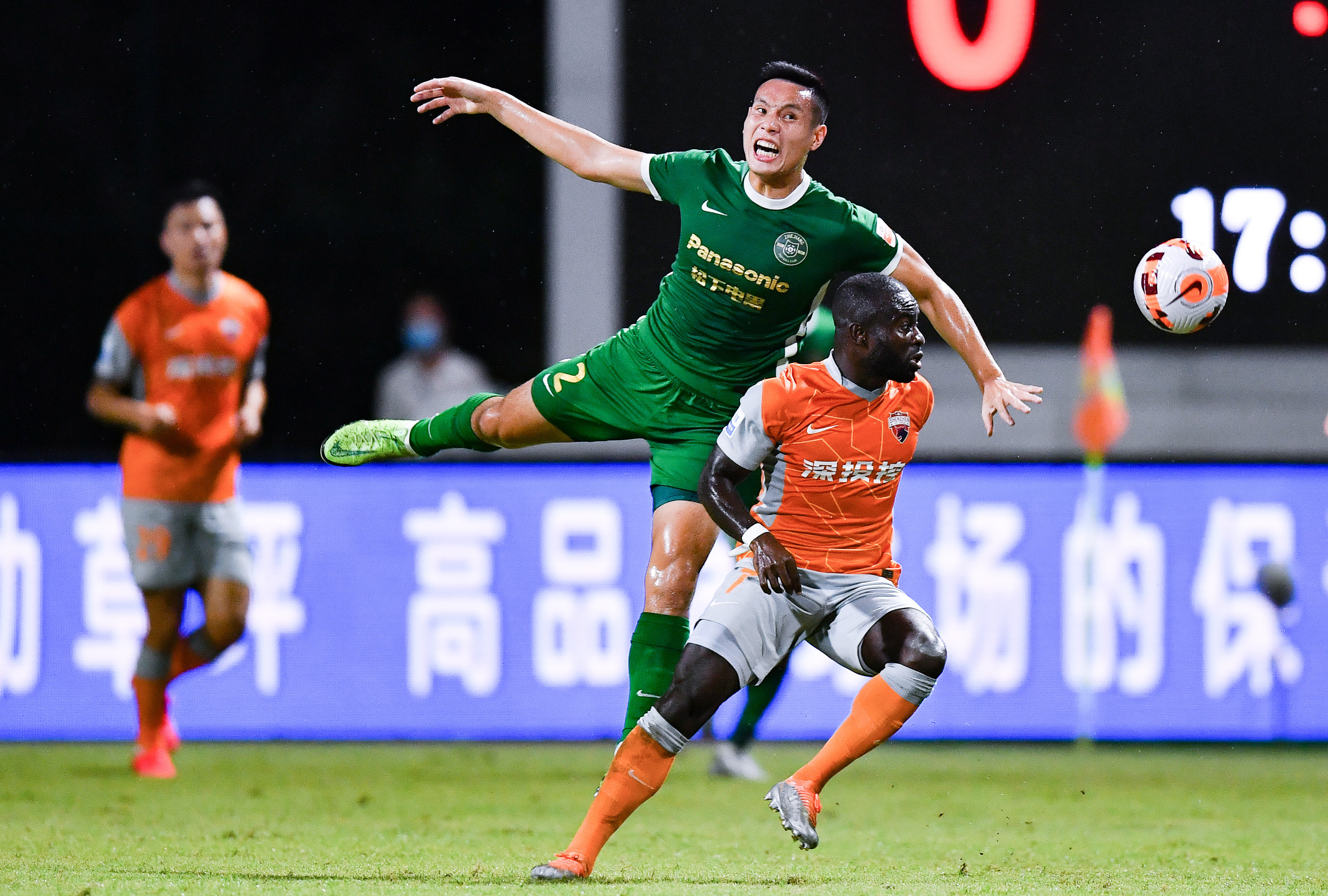 Shenzhen’s Frank Acheampong (right) battles for the ball with Zhejiang’s Liang Nuoheng during a Chinese Super League match in Haikou on Friday August 5. Photo: Xinhua