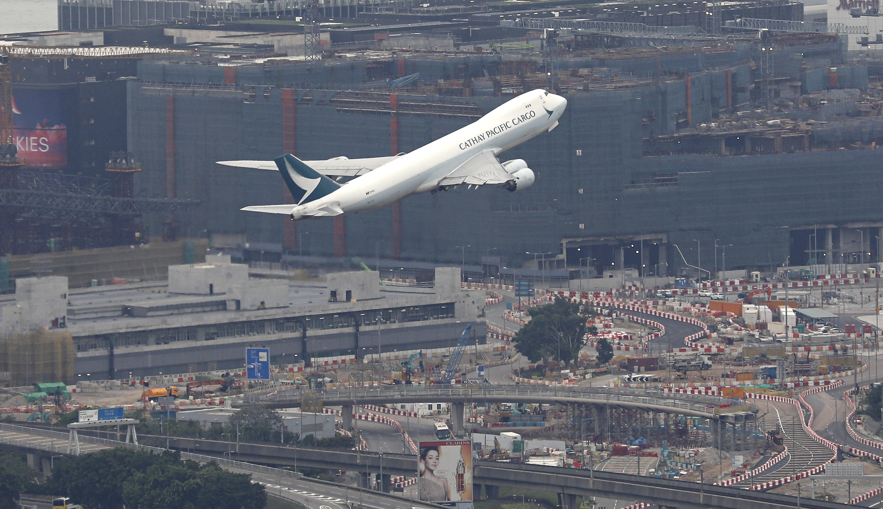 A Cathay Pacific cargo plane takes off in March 2022, above the third runway that is under construction at Chek Lap Kok. Photo: Yik Yeung-man