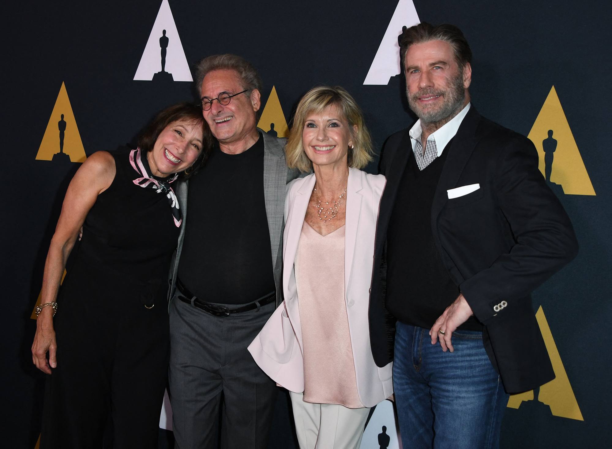 Didi Conn, Barry Pearl, Olivia Newton-John and John Travolta pose on the red carpet for the 40th anniversary celebration of Grease. Photo: AFP