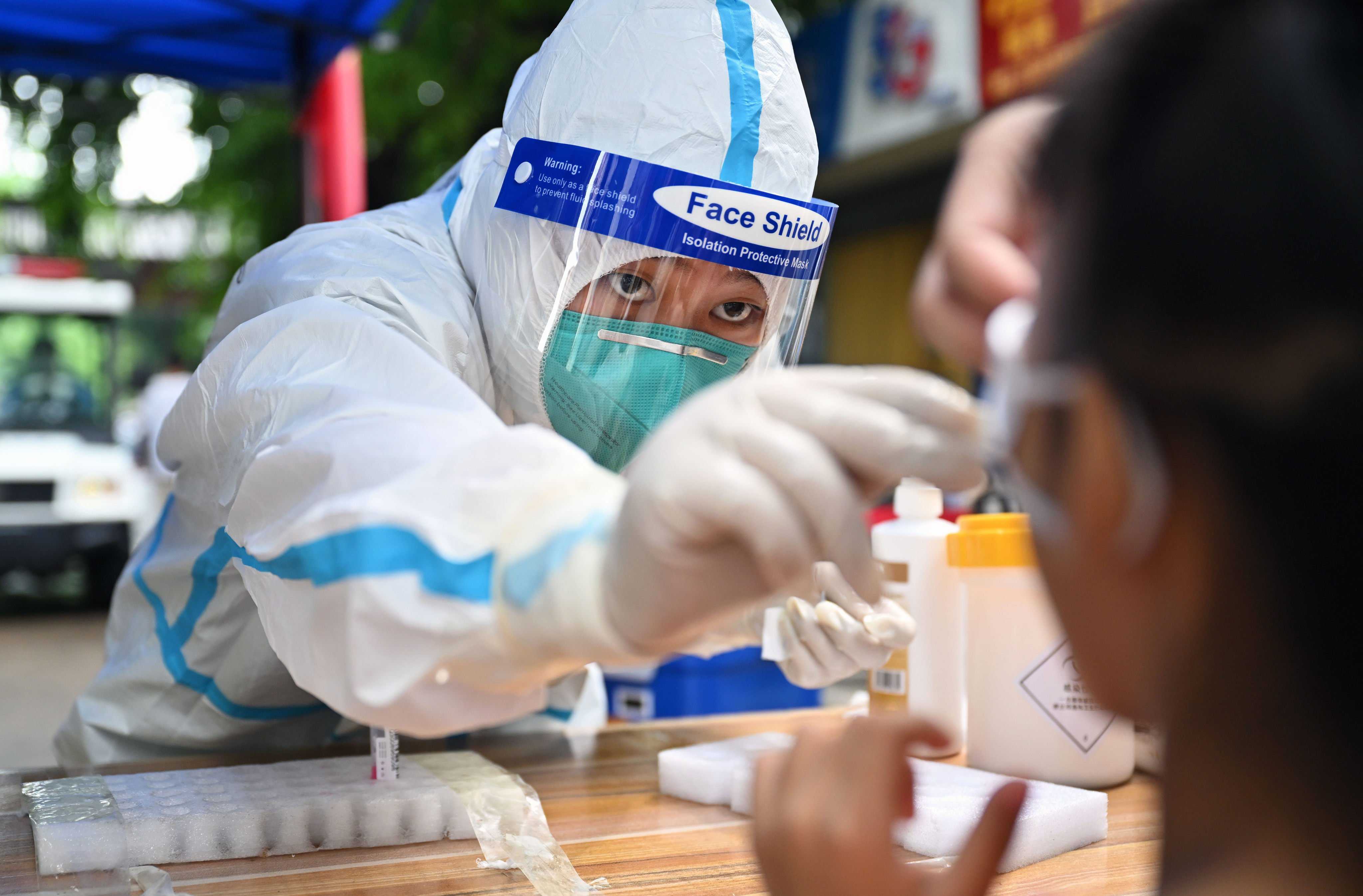 A medical worker takes a swab sample for Covid-19 testing from a person in Sanya, Hainan province, on Thursday. Photo: Xinhua