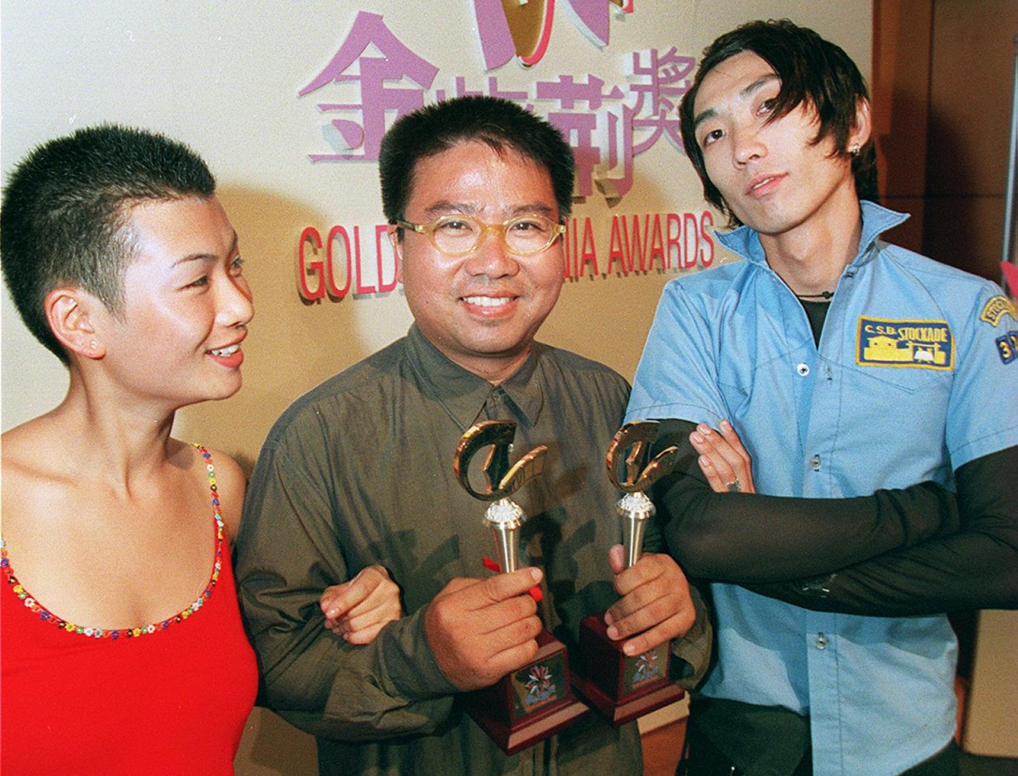 Fruit Chan (centre), winner of Best Director and Best Picture at the 3rd Golden Bauhinia Awards Ceremony, alongside actors Neiky Yim (left) and Sam Lee, in 1998. Photo: SCMP