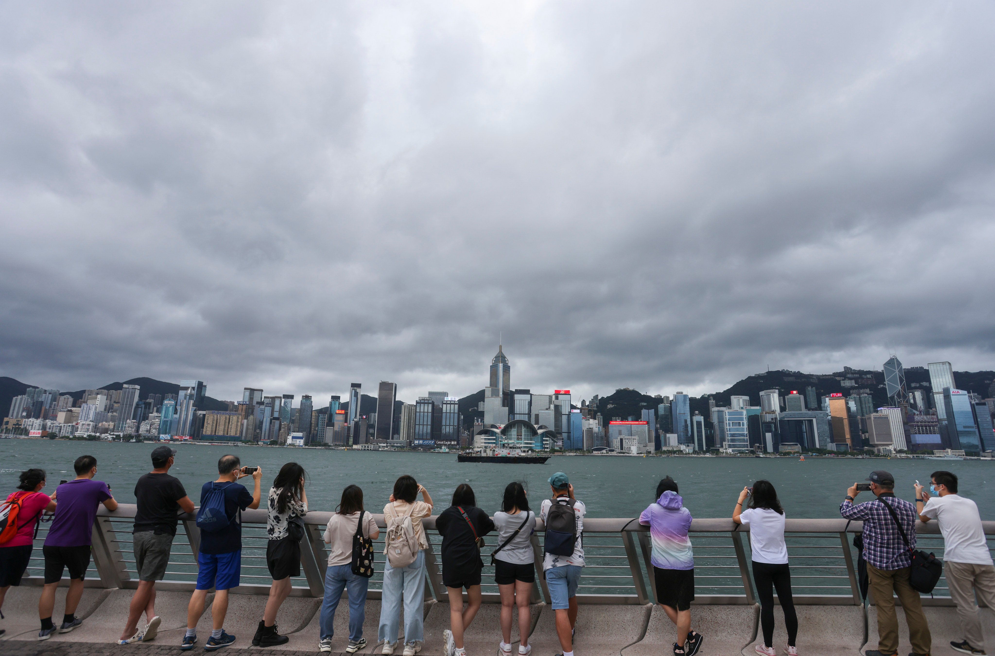 Hongkongers in Tsim Sha Tsui take photos of Victoria Harbour on the 25th anniversary of the establishment of the Hong Kong Special Administrative Region on July 1. Photo: Nora Tam