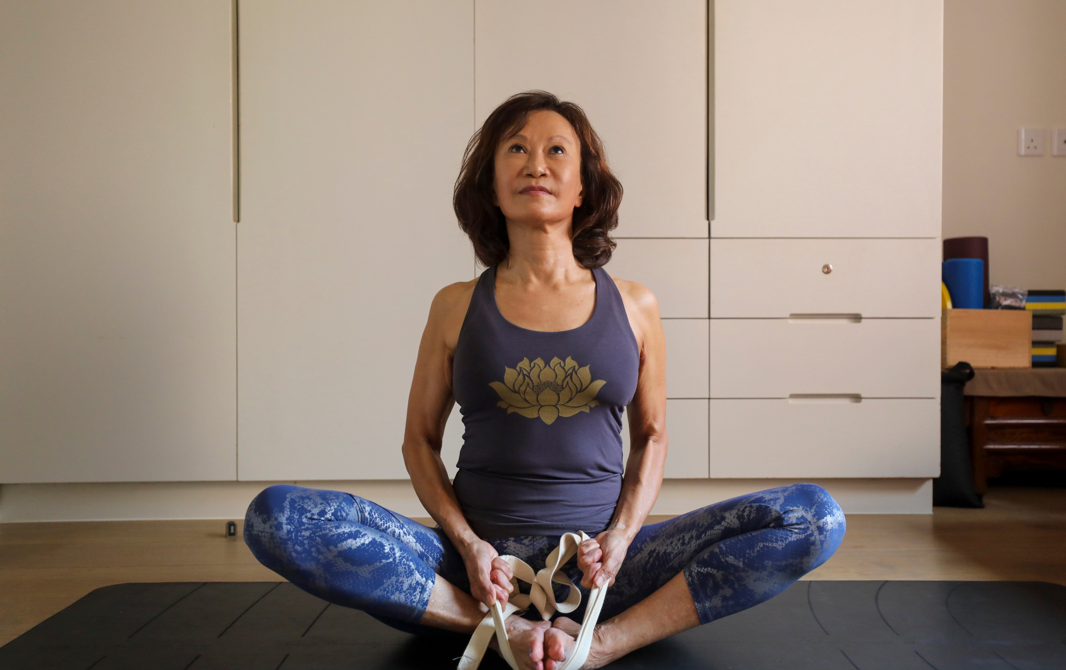 Theresa Brickley does yoga at her home in Tai Tam, Hong Kong. The 69-year-old says keeping fit while listening to your body is key to slowing the ageing process. Photo: Xiaomei Chen