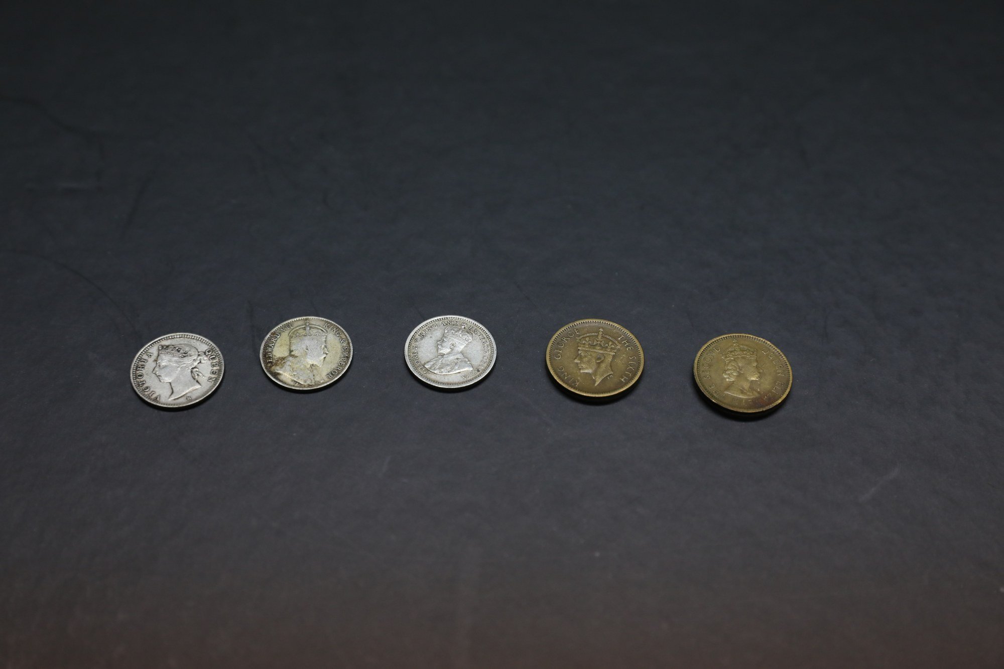 (L-R) Hong Kong’s five-cent coins minted in 1891,1904,1932,1948 and 1965, bearing the visages of the reigning British monarchs at the time, on display at Commonwealth Stamp & Coin in Sheung Wan on 9 July 2022. Photo: Yik Yeung-man