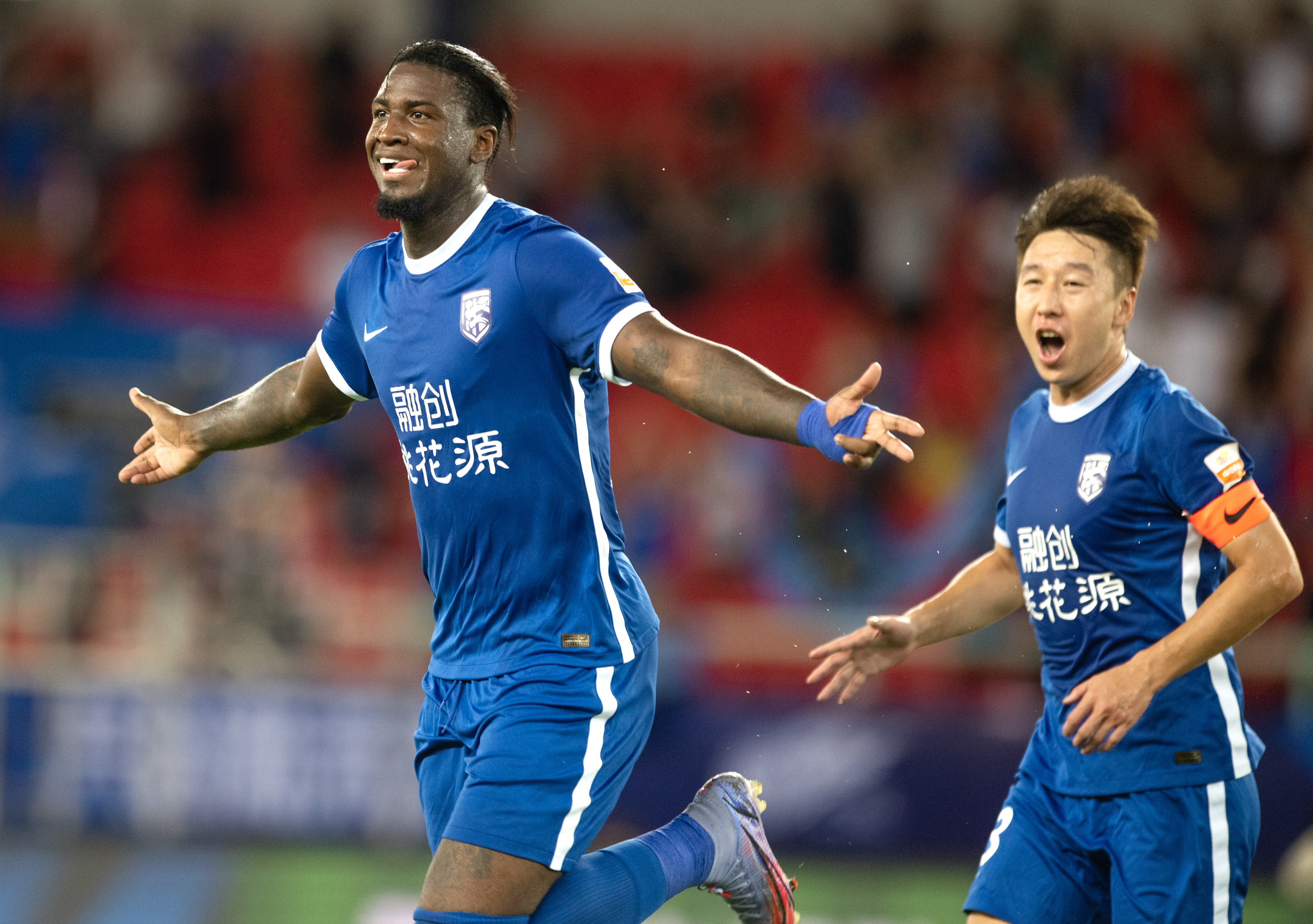Marcos Vinicius Amaral Alves (left) of Wuhan Three Towns celebrates scoring against Beijing Guoan in the Chinese Super League. Photos: Xinhua