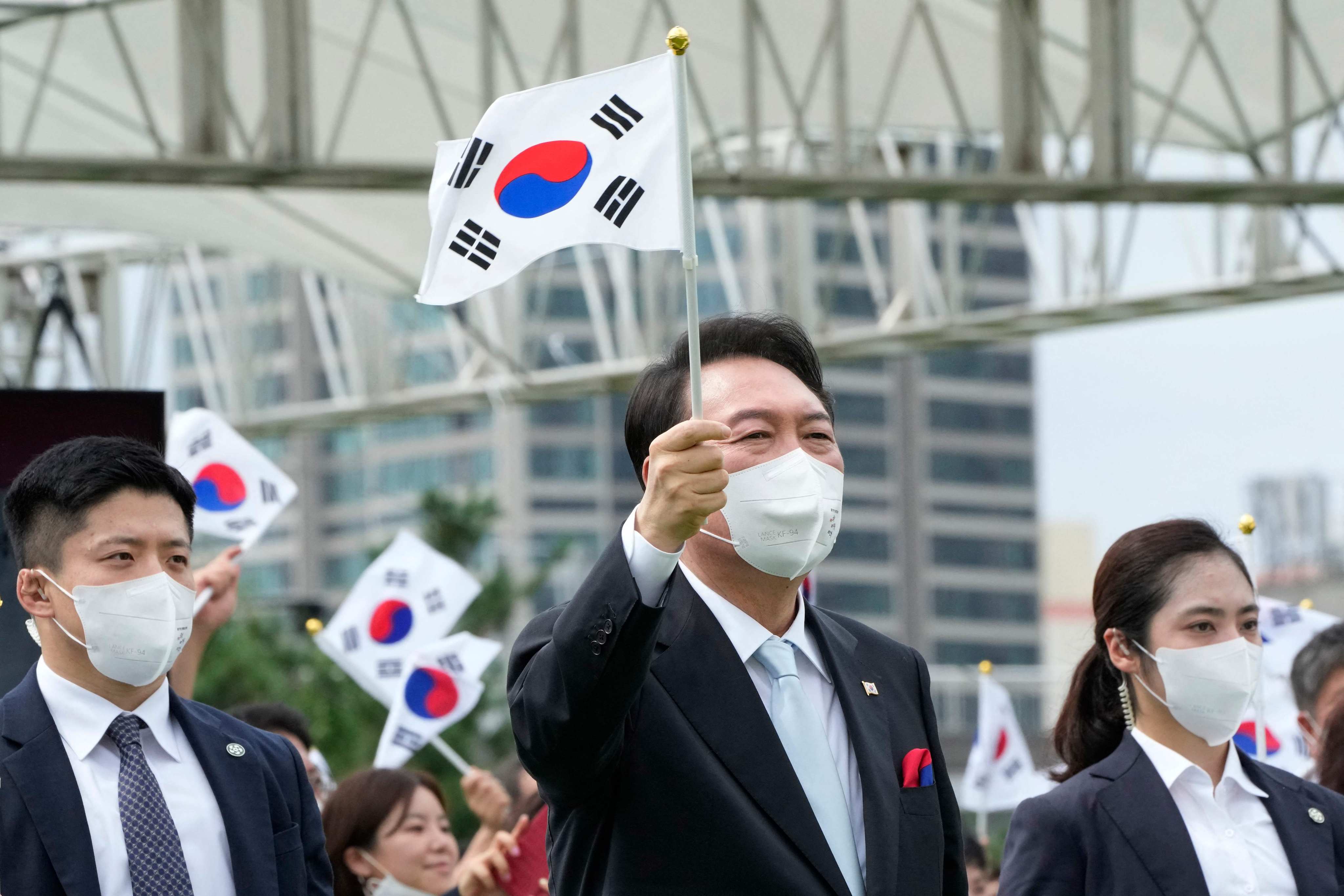 President Yoon Suk-yeol waves a South Korean flag during a ceremony in Seoul on Monday to mark Korean Liberation Day. Photo: AFP