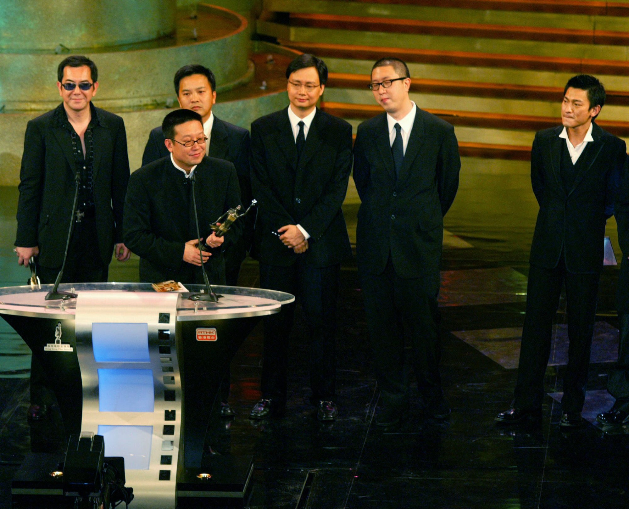 Andrew Lau Wai-keung accepts his best film trophy for Infernal Affairs at the 22nd Hong Kong Film Awards. Behind (from left to right): Anthony Wong (best supporting actor), Alan Mak (best director), executive producer Jol Chong, Felix Chong (best screenplay) and Andy Lau (best original film song). Photo: SCMP