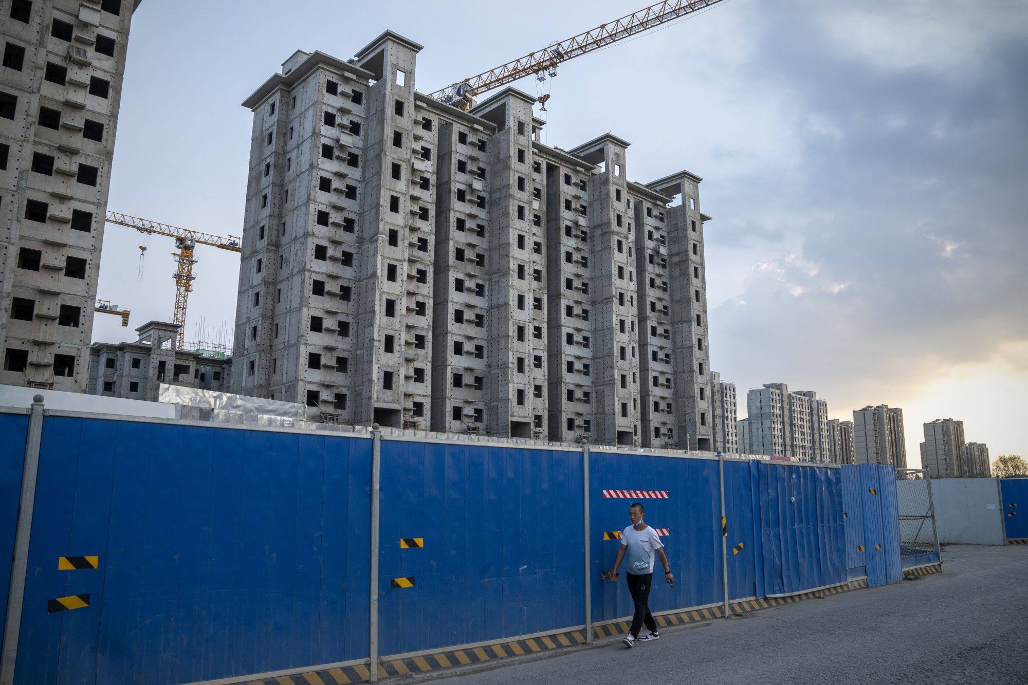 A man walks past China Evergrande Group’s Royal Peak residential development under construction in Beijing last month. Photo: Bloomberg