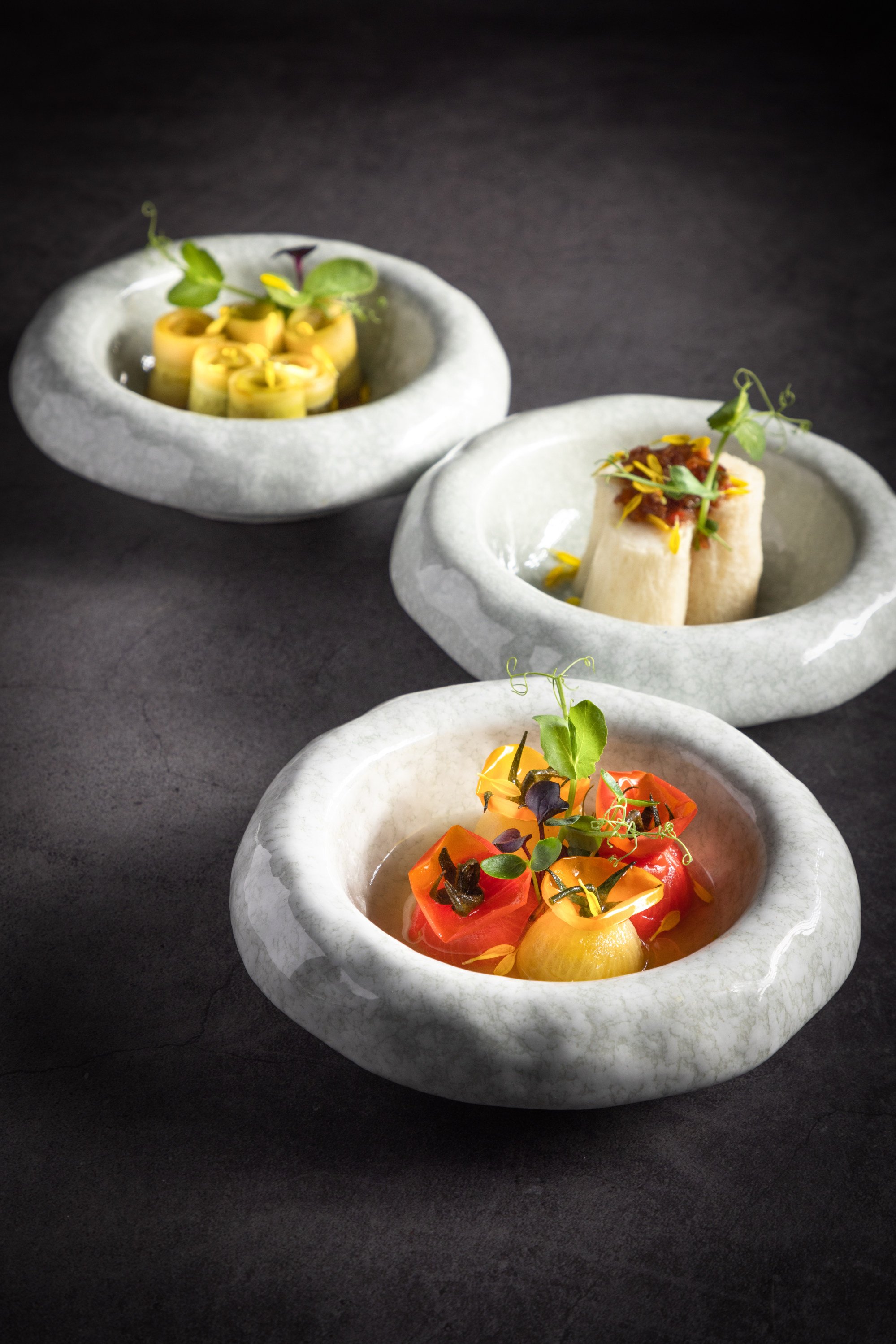 (From front) Mixed cherry tomatoes stuffed with sweet ginger tomato jelly, marinated in sweet plum hua diao wine; bamboo fungus stuffed with scallop mousse with a home-made premium XO sauce; chilled Japanese cucumber with yuzu soy sauce, all at Hong Kong Cuisine. Photo: Hong Kong Cuisine
