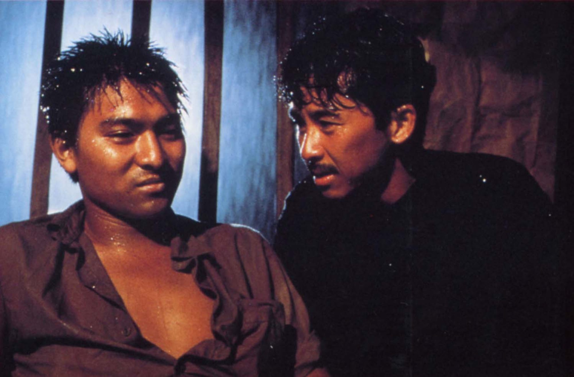 Andy Lau as To Minh (left) and George Lam as Akutagawa in a still from Boat People.