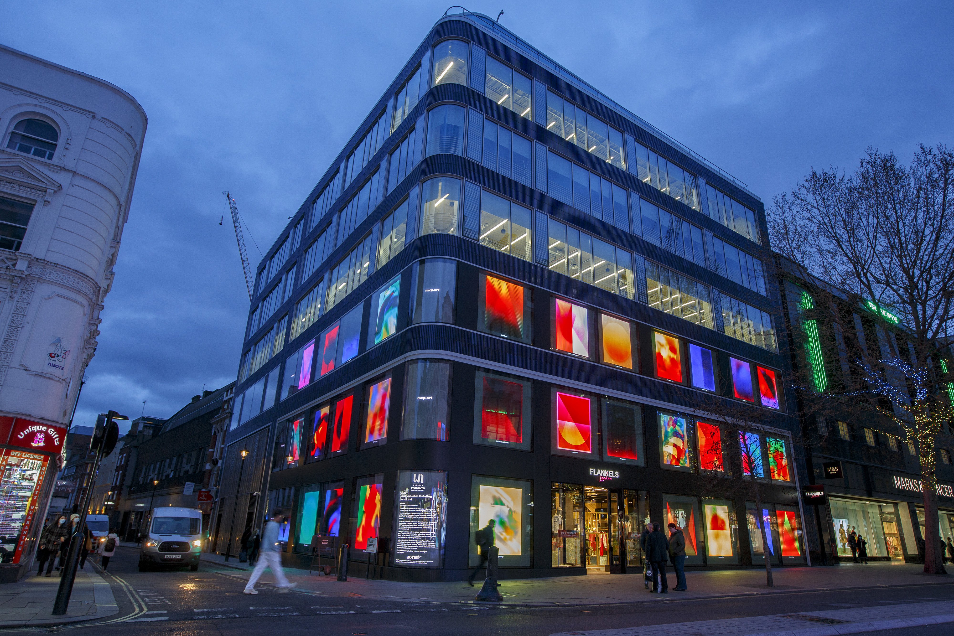 A series of NFT artworks collectively titled ‘MVP Most Valuable Painting’ by artist Jonas Lund is displayed on screens in the windows of The Flannels Group department store on Oxford Street in London on April 4. Photo: Bloomberg