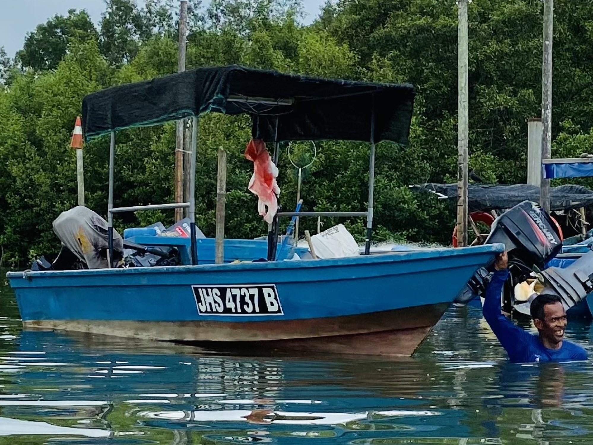 Indasari returns from washing a boat along the jetty of Mukim Tanjung Karang in Johor. Photo: Ushar Daniele