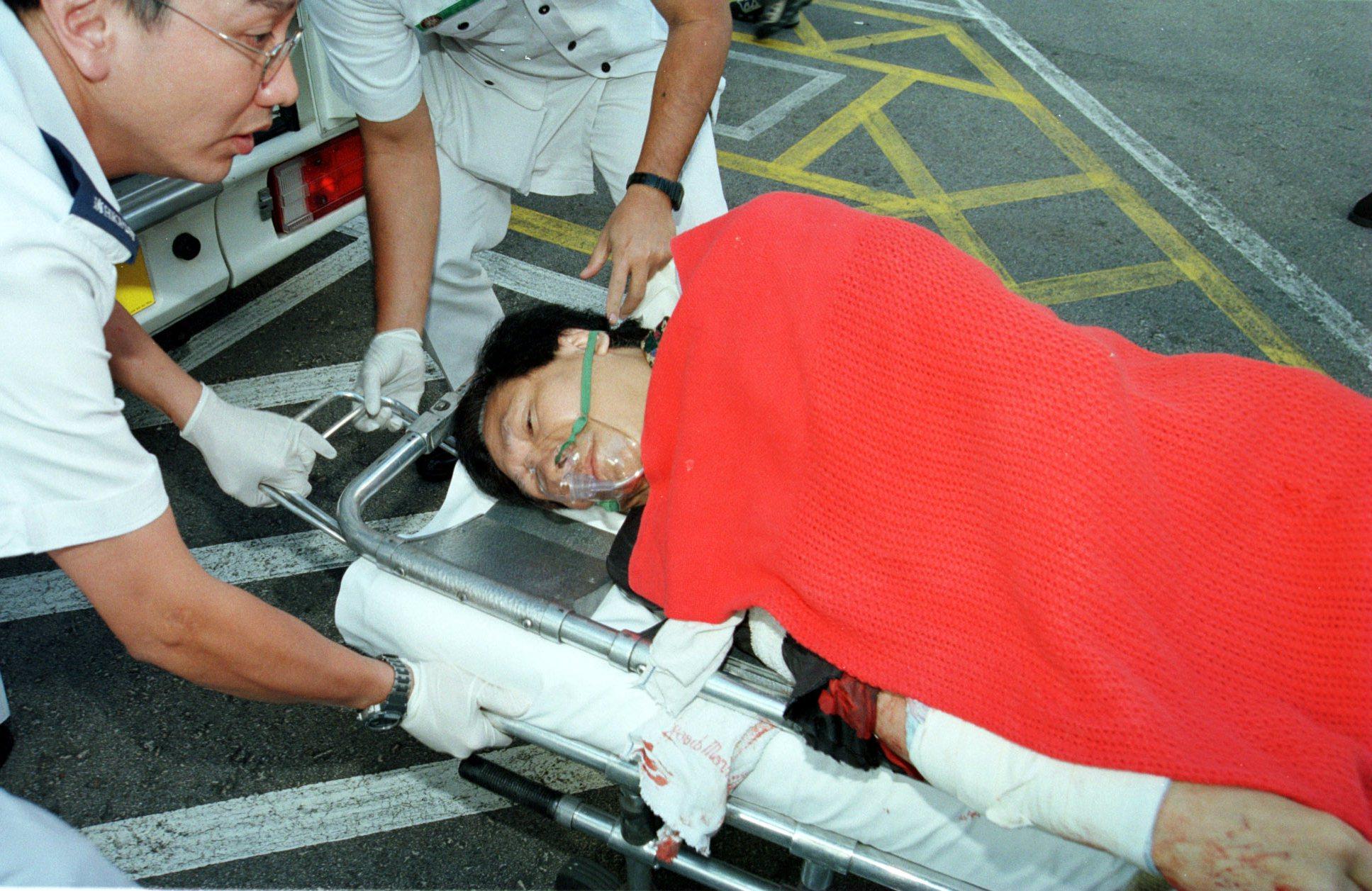 Radio personality Albert Cheng King-hon is taken to hospital after he was severely wounded in a knife attack outside the Commercial Radio building in 1998. Photo: SCMP