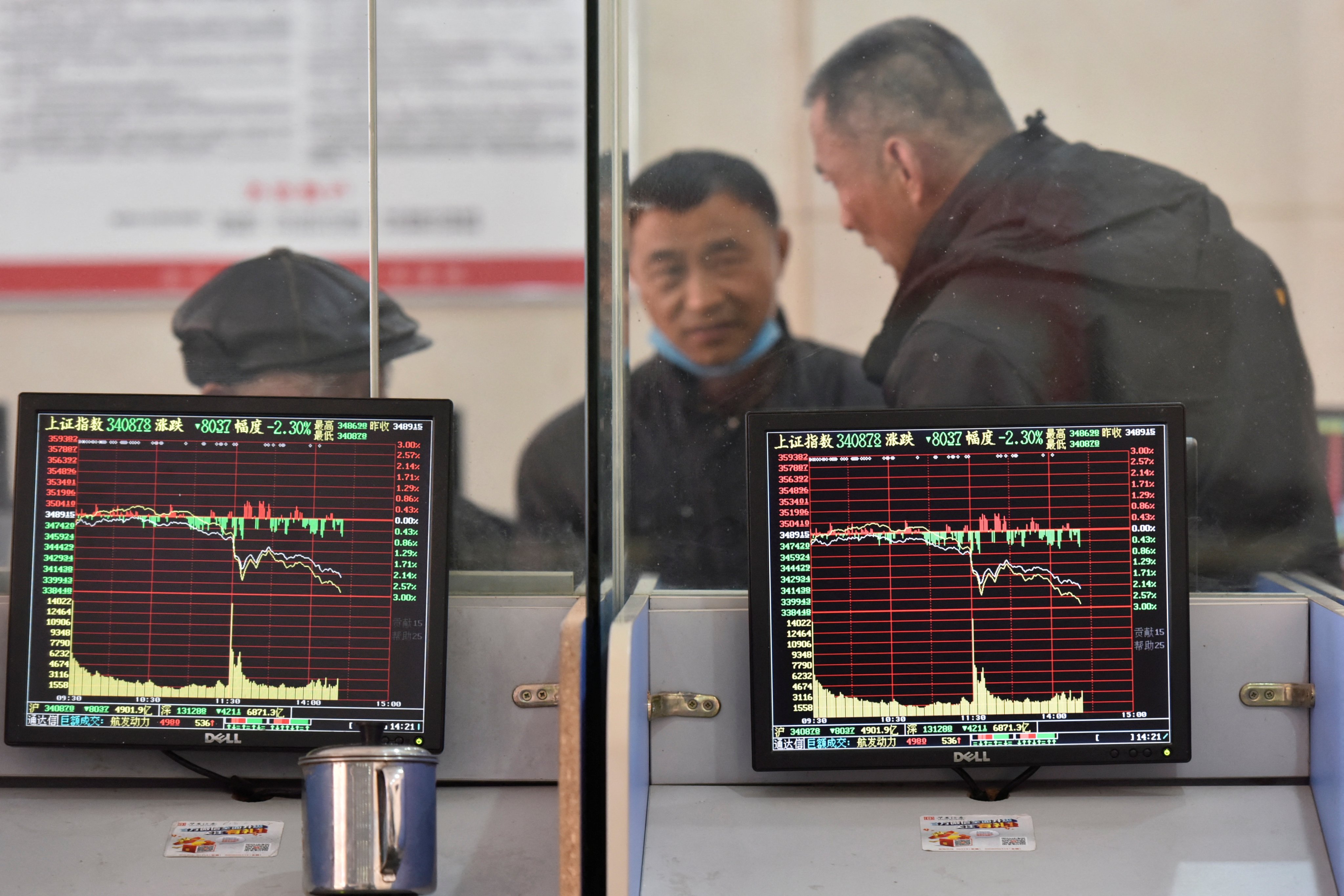 Investors talking about markets inside a brokerage in Anhui province in February 2022. Photo: Reuters